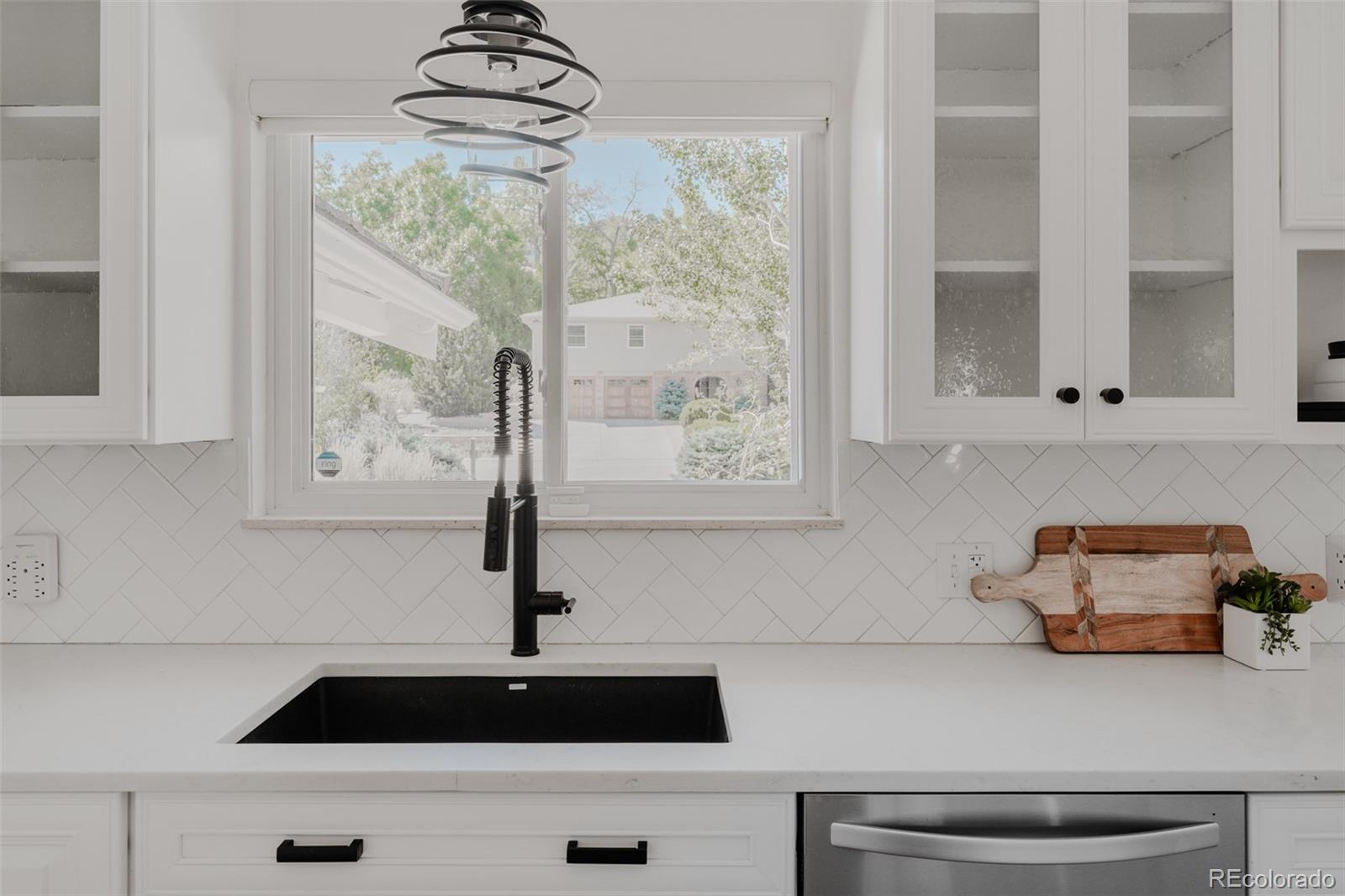 A window above the kitchen sink lets natural light flood in, creating a cheerful atmosphere for daily kitchen tasks.