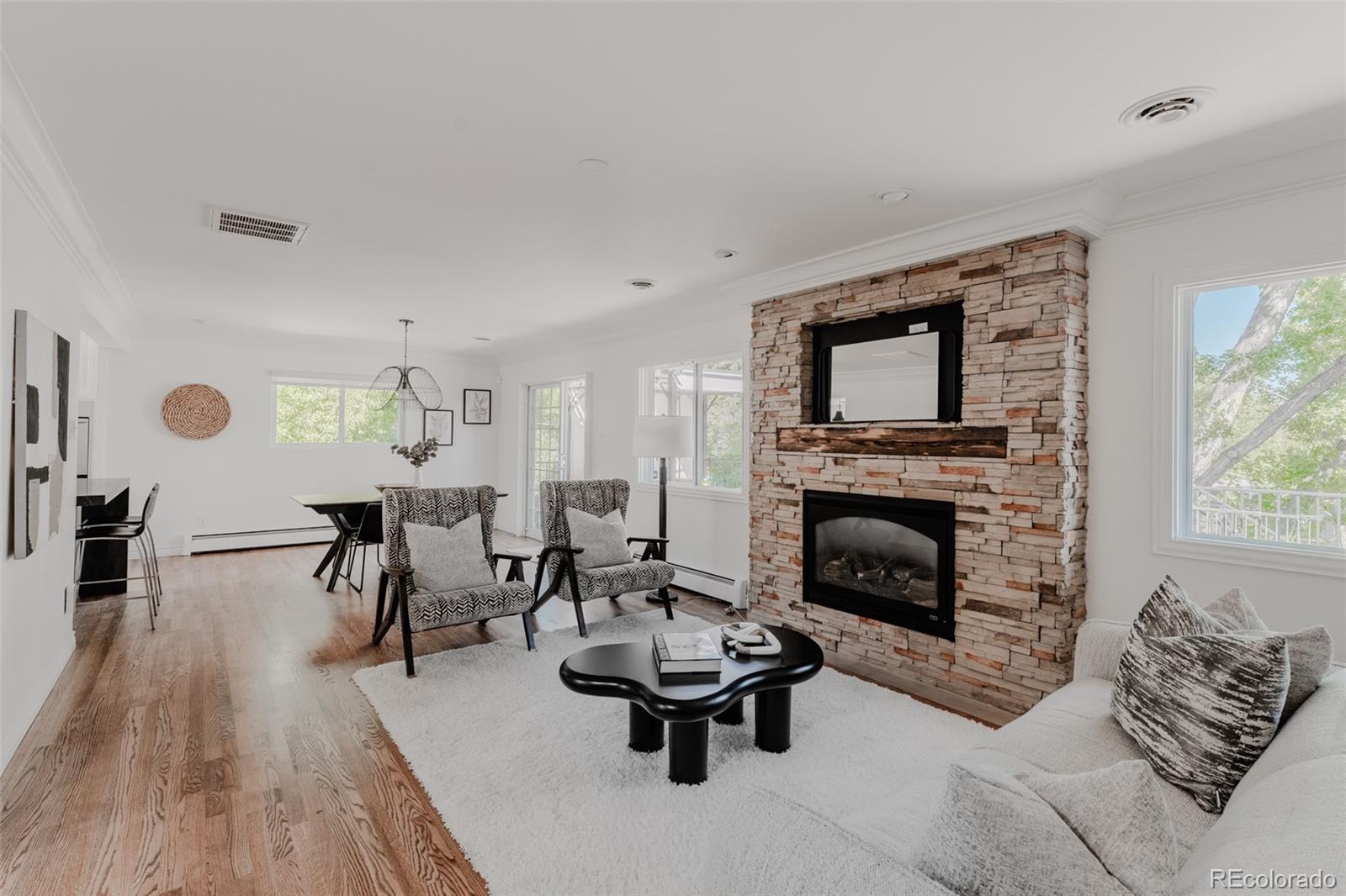 A stacked stone fireplace inlaid with timber commands attention as the focal point of the family room.