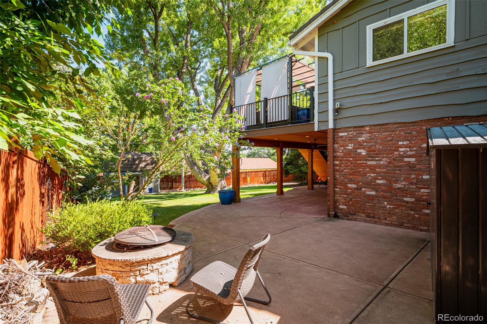 The patio extends the length of the home and wraps around to a cozy fire pit, perfect for roasting s'mores and enjoying warm, fireside gatherings under the stars.