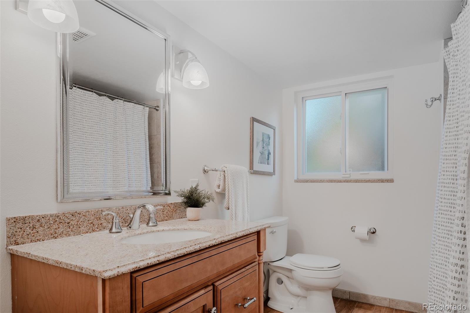 A full shared basement bathroom combines practicality with style to accommodate multiple users with ease.