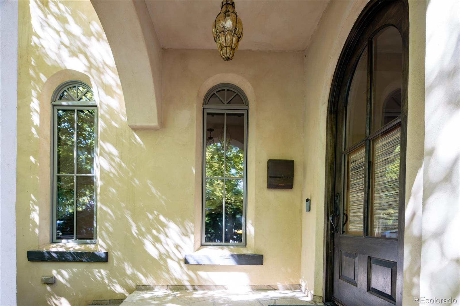 Entryway with Solid Wood Door and Handblown Italian Glass Lighting