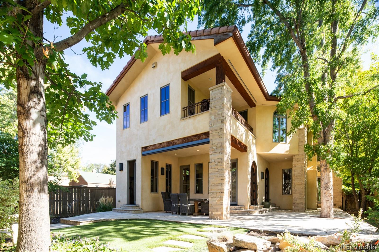 Back of Home with covered patio and sun shade