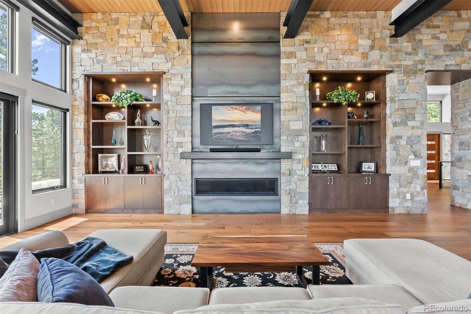 The expansive great room captivates with its impressive 20-foot wood ceilings