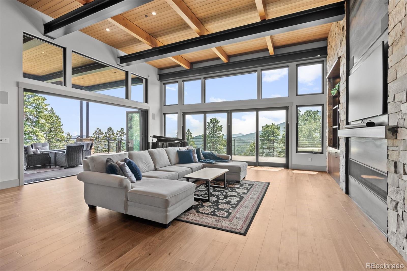 Large windows and La Cantina style sliding door that opens to the spacious deck, showcase breathtaking mountain views