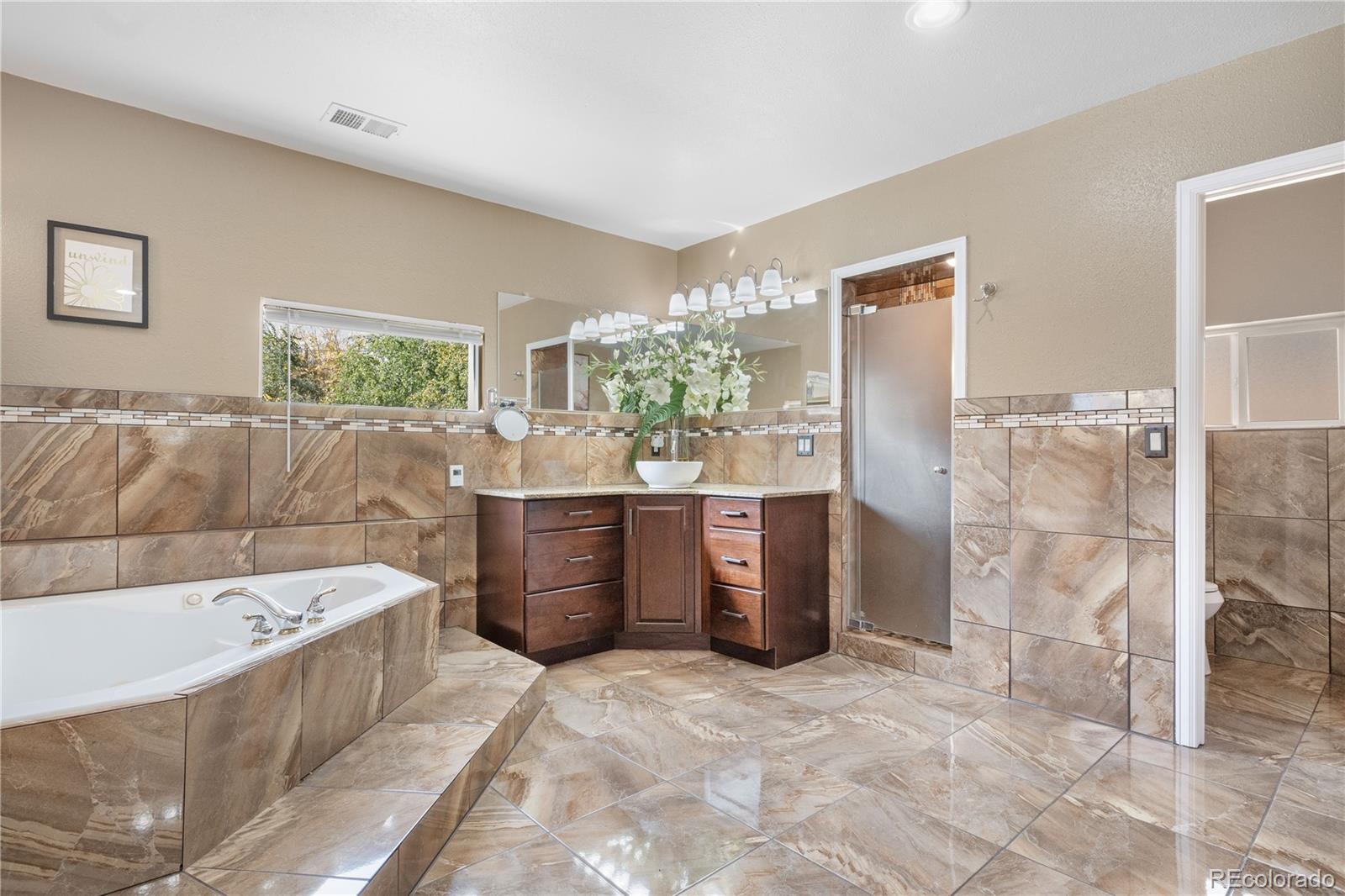 Primary bath complete with heated floor in the bathroom as well as the shower.