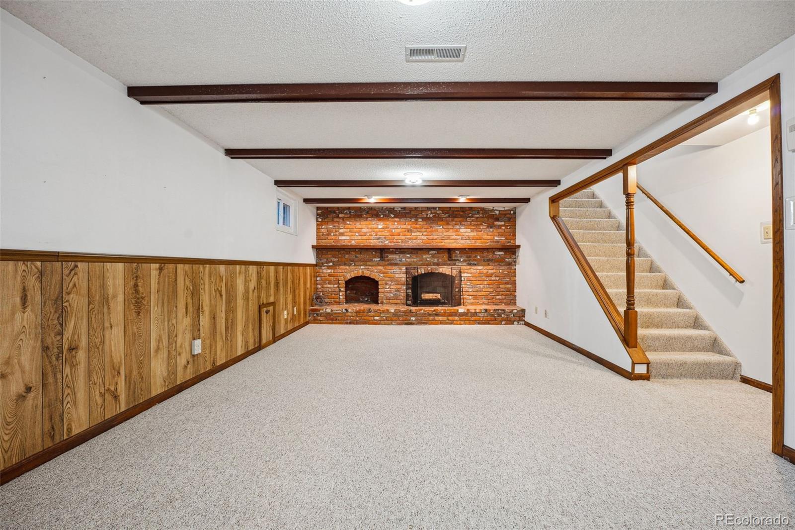 Very large family room with a wood-burning fireplace.