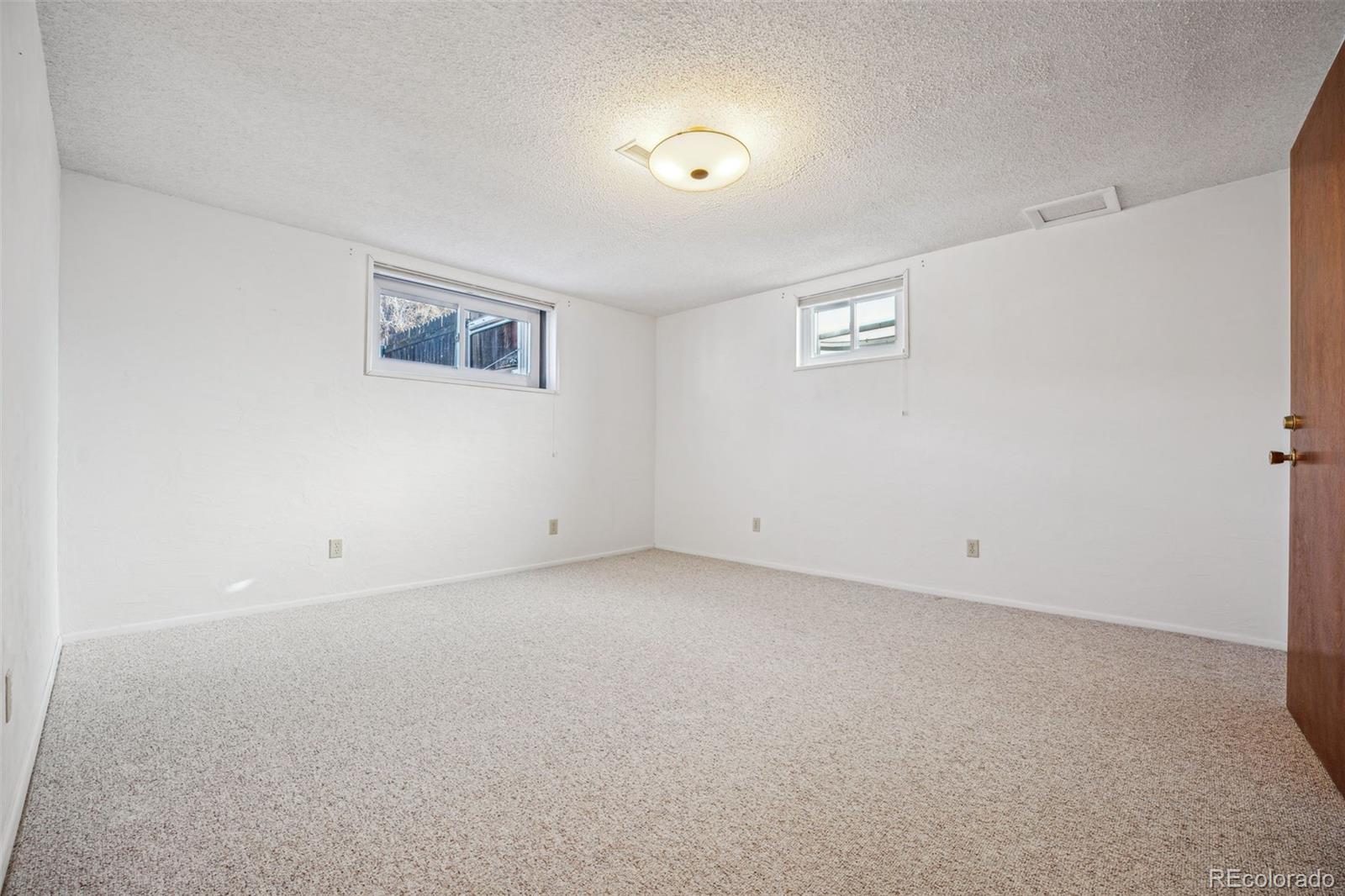 Carpeted bedroom, non-conforming as window is large but not full egress