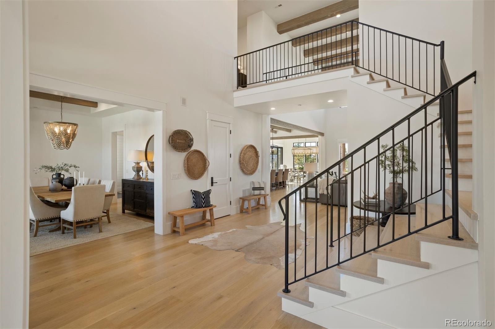 Gorgeous modern farmhouse design with 22' ceilings with natural beams and wide-plank white oak flooring.