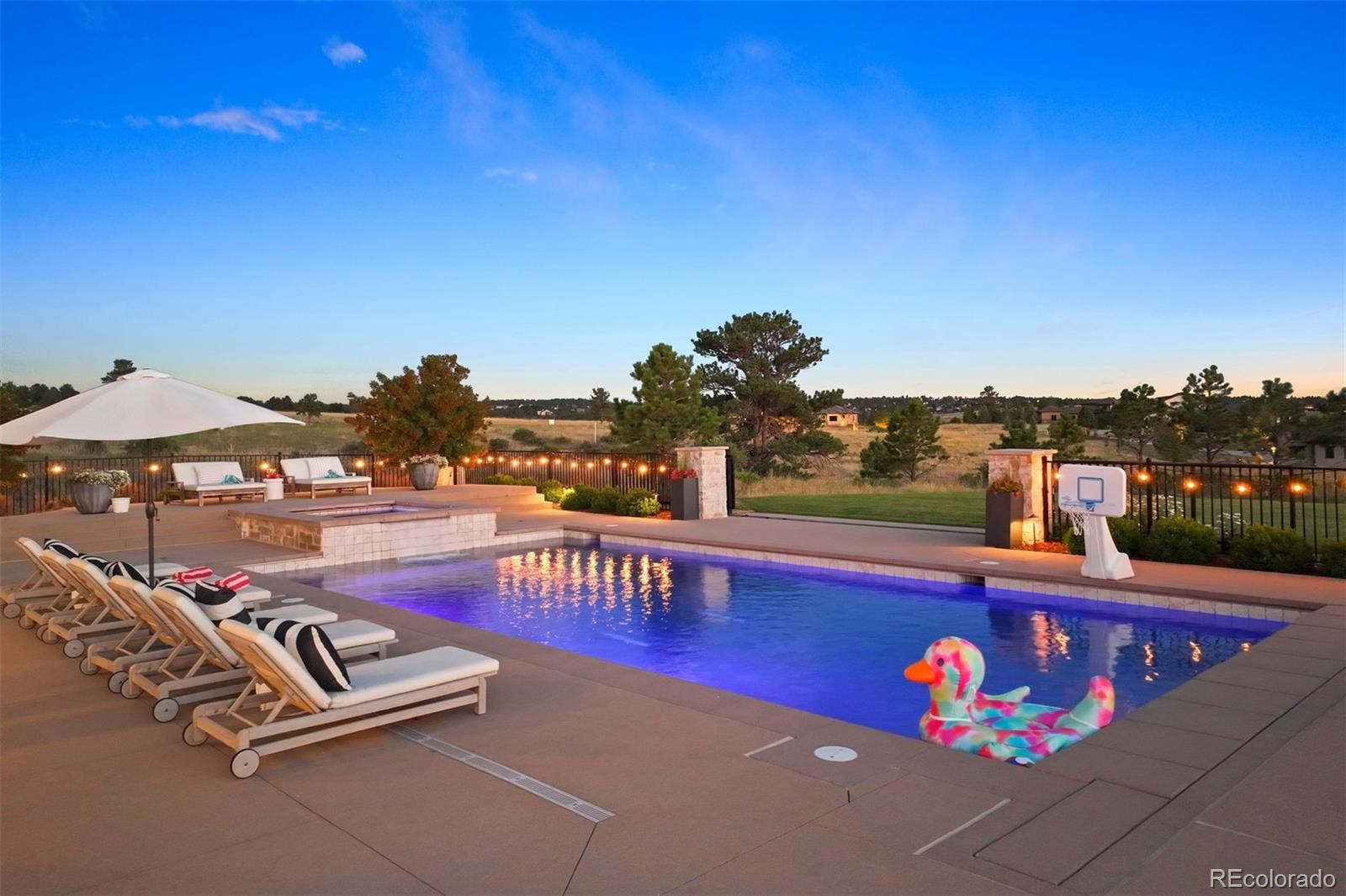 Expansive pool deck with multiple sitting areas.