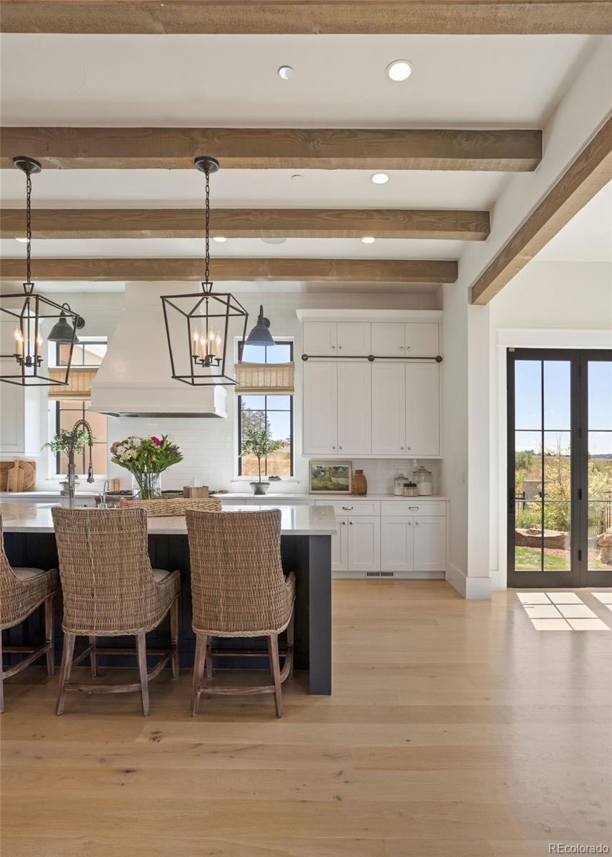 White oak beams on the ceiling with Restoration Hardware® lighting.