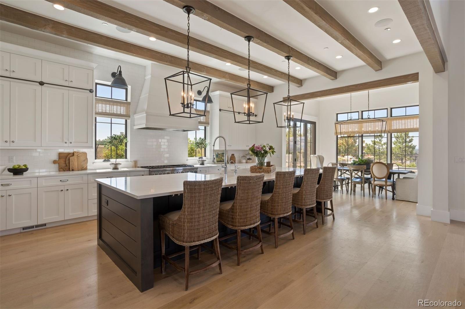 Custom white cabinetry runs all the way to the ceiling with a ladder rail.