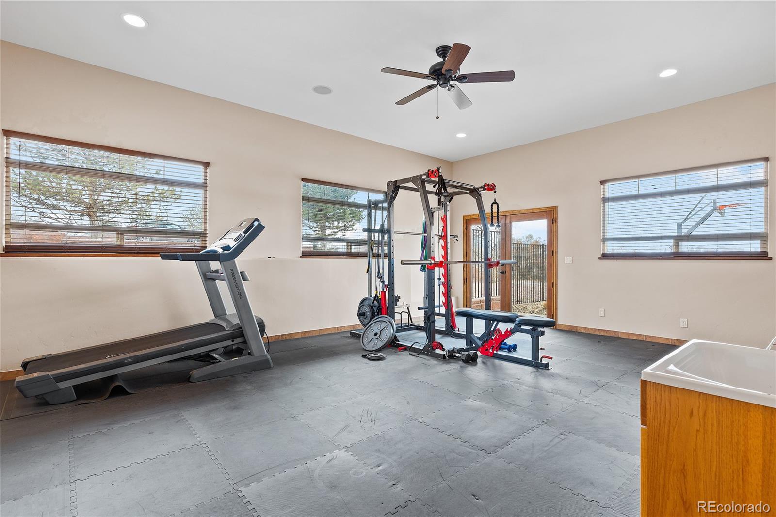 Gym area leading with a doorway leading out to the sport court!