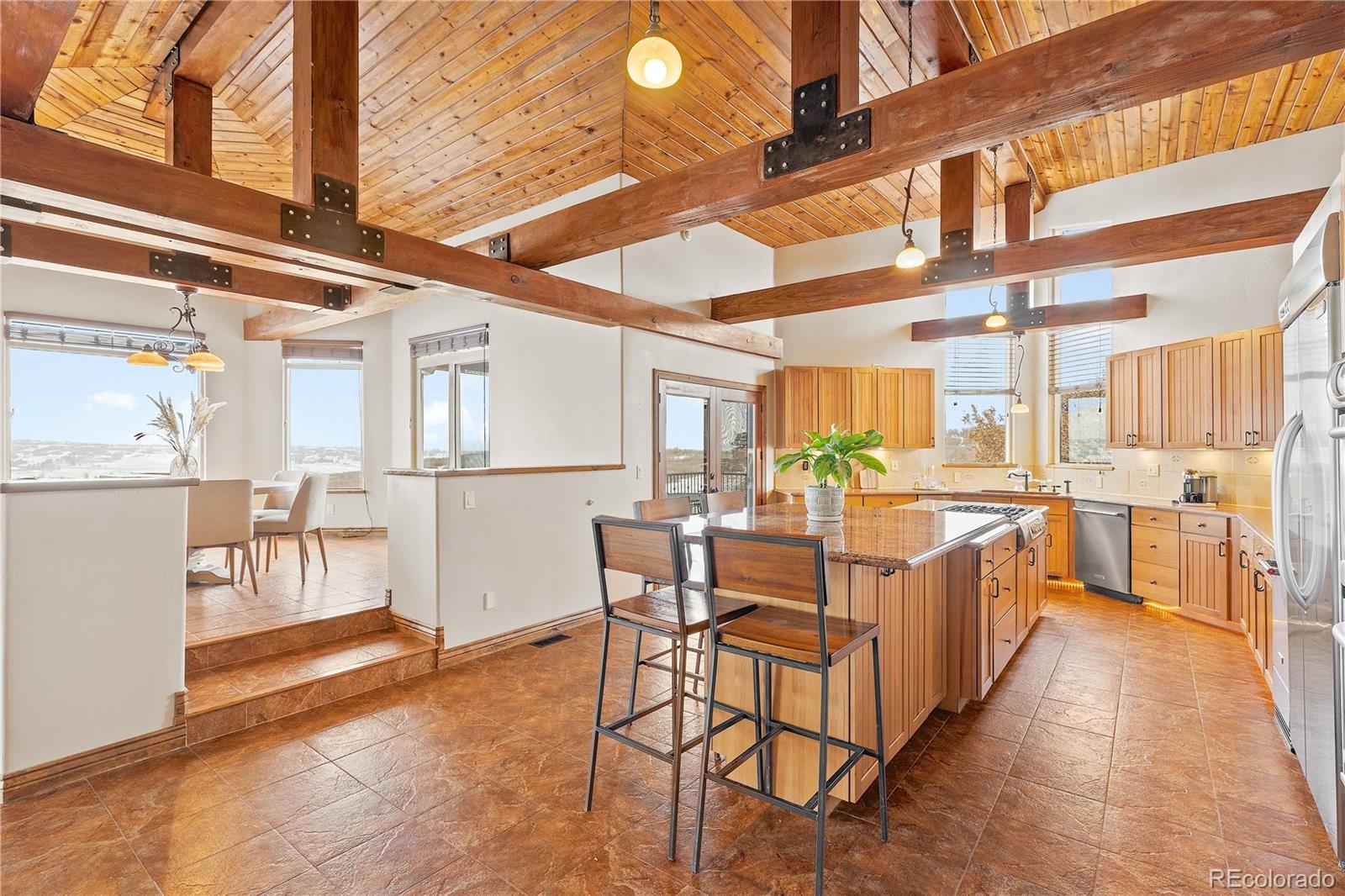 Open kitchen with views and elevated breakfast dining area.