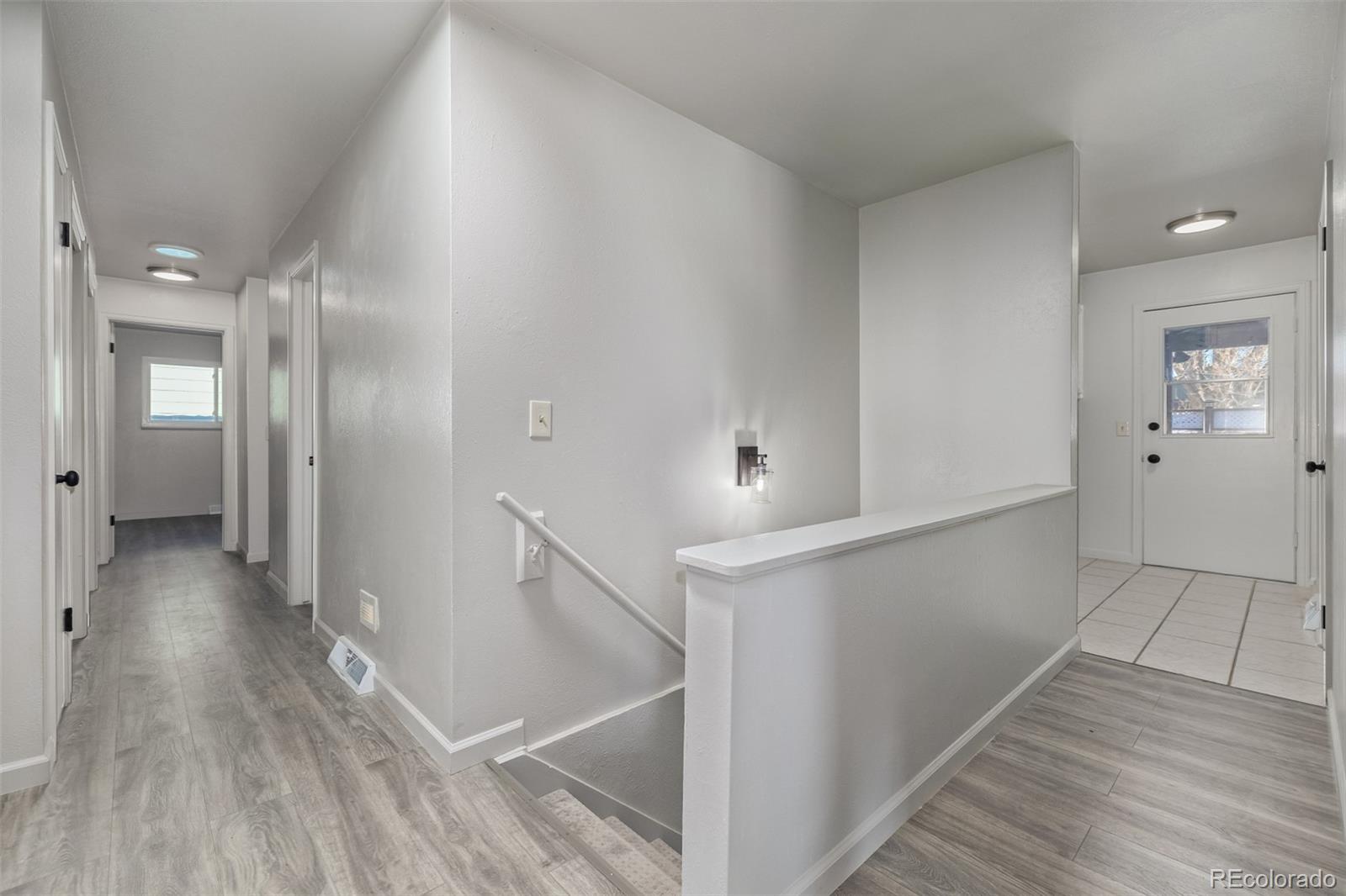 Hallway to bedrooms, laundry room and basement