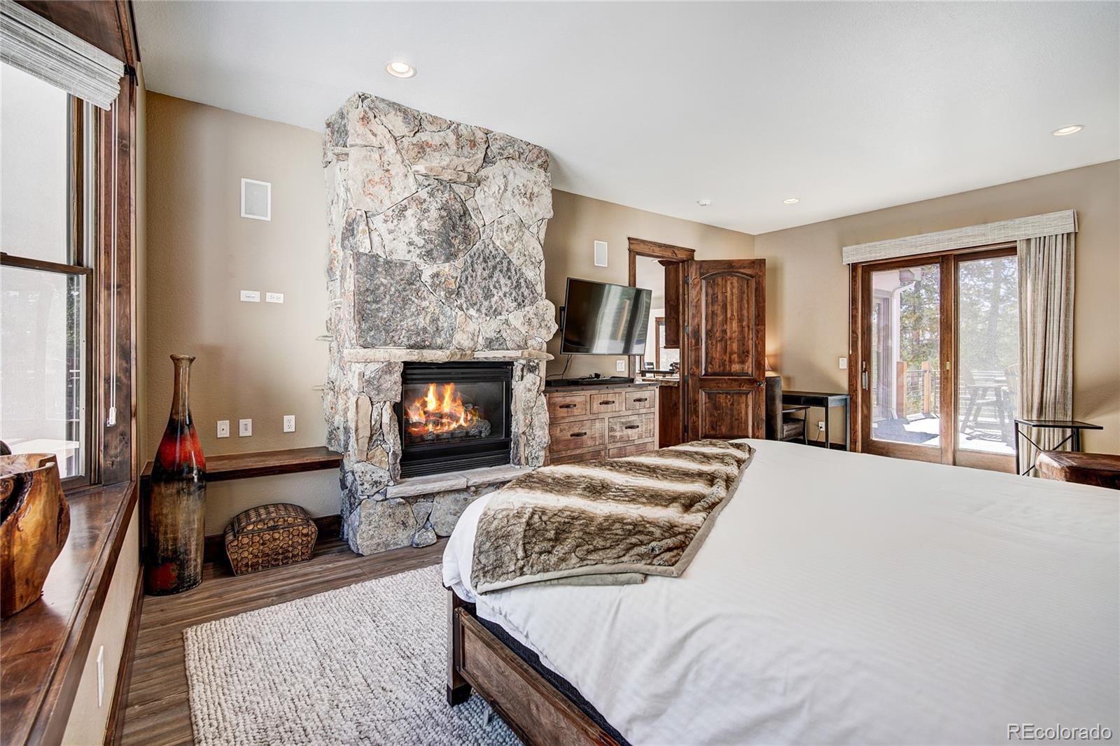 beautiful stone fireplace in main floor primary suite