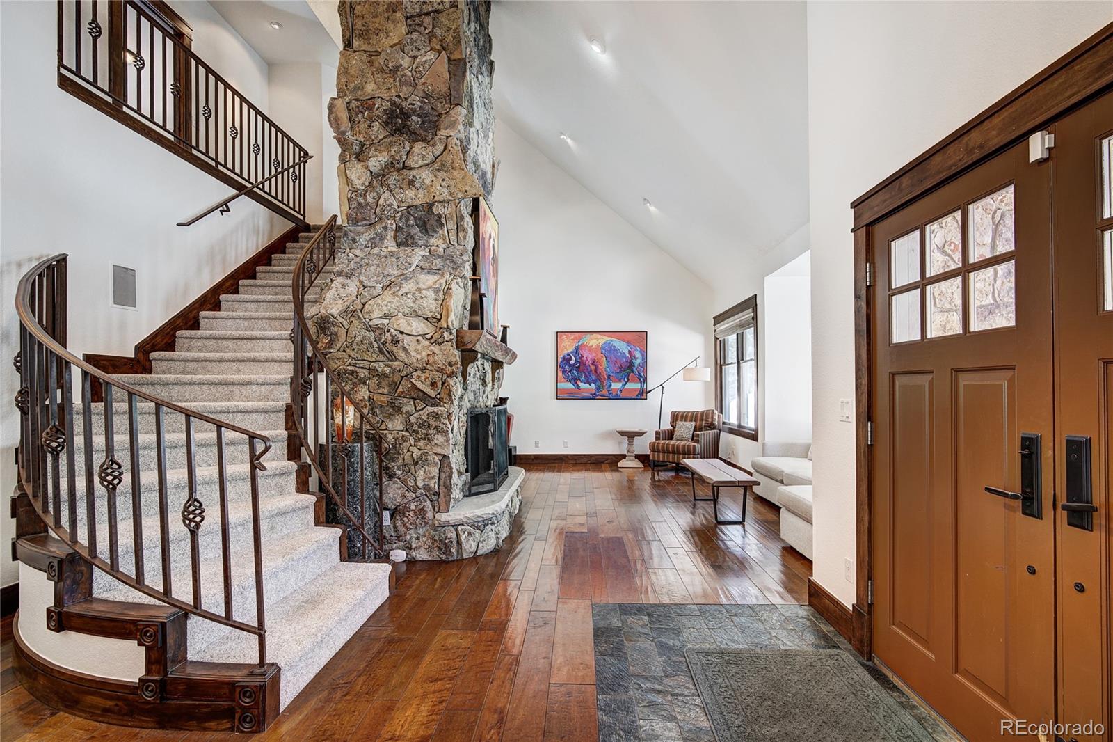 elegant entry w/towering stone fireplace