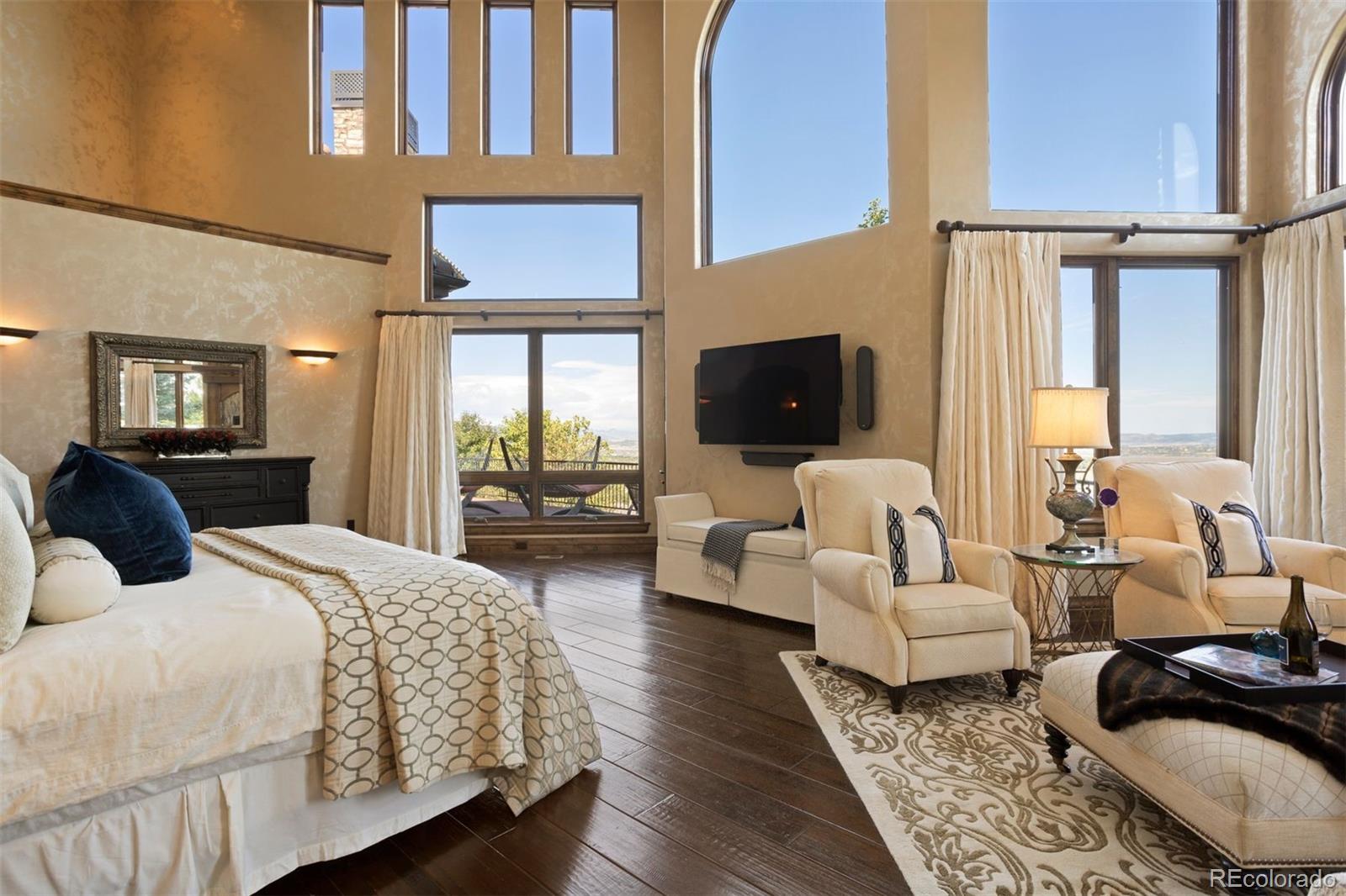 The primary bedroom has vaulted ceilings and soaring windows with mountain views.