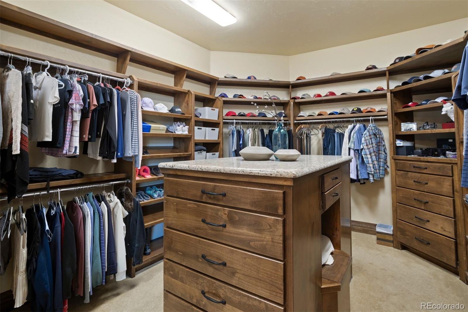 Primary suite's walk-in closet with island.