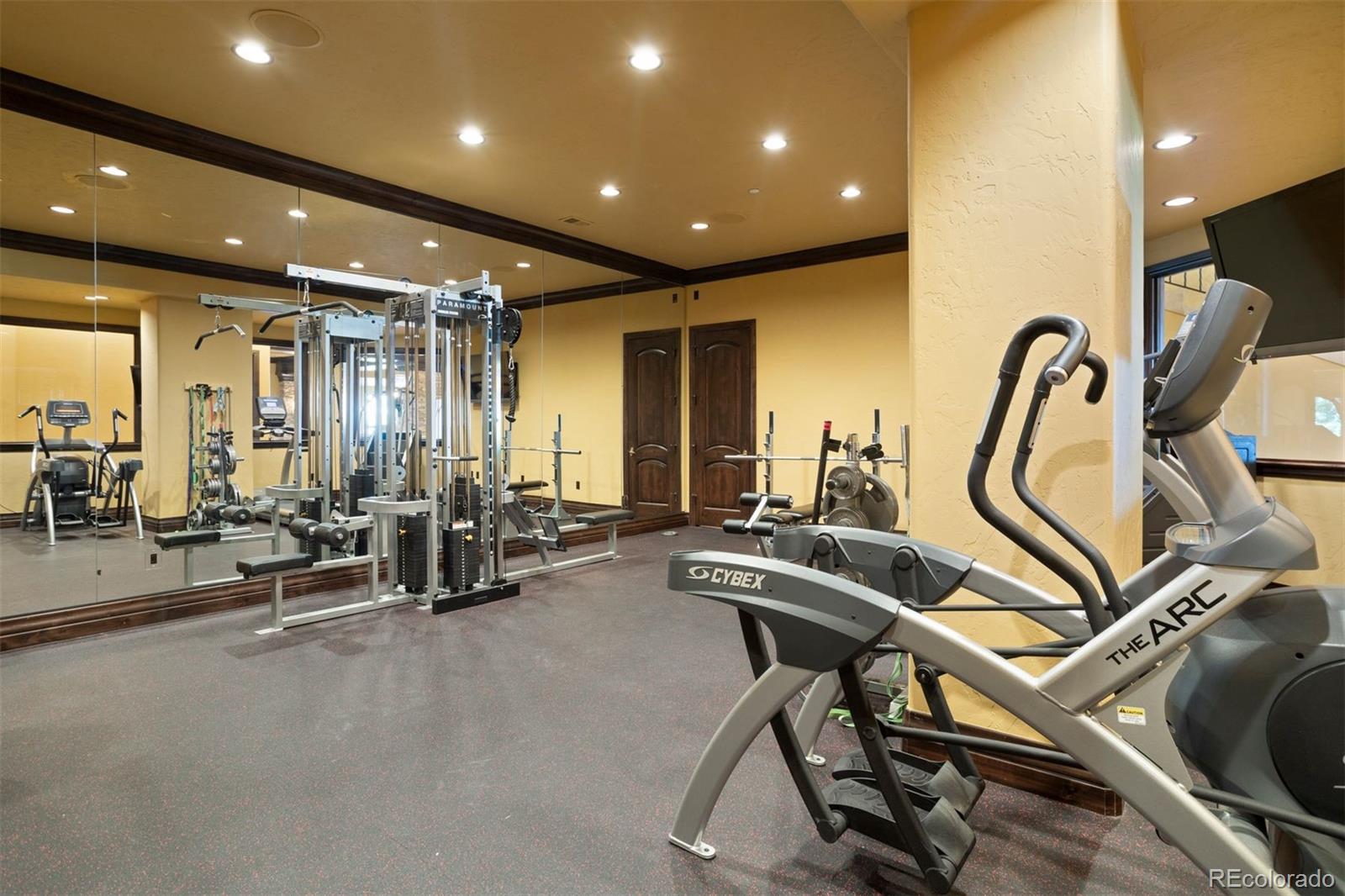 The gym is professional-sized with room for multiple machines.