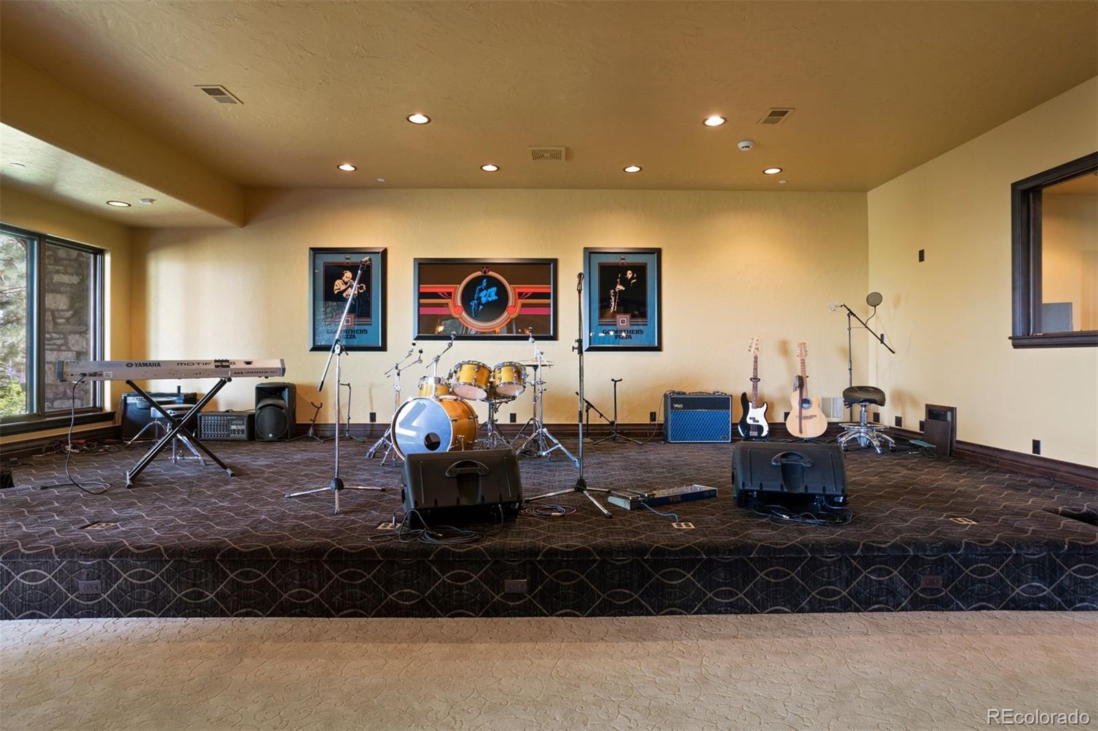 Music room with stage and audio equipment.