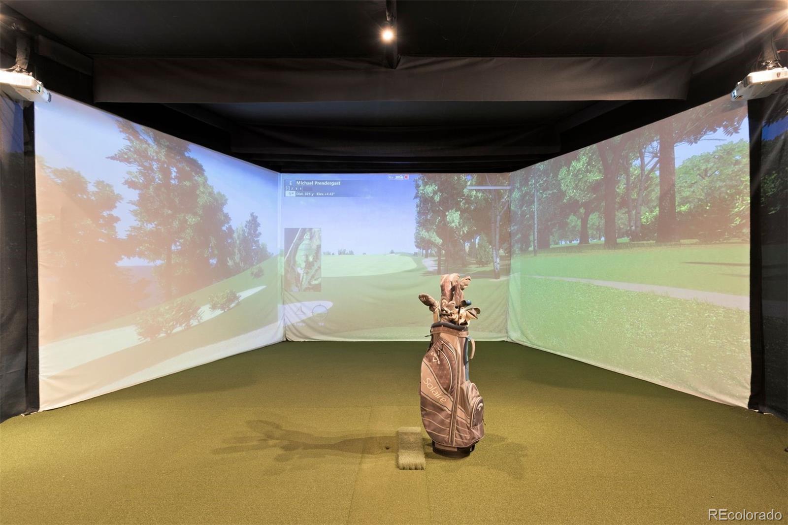 Golf simulator lounge with sitting area.