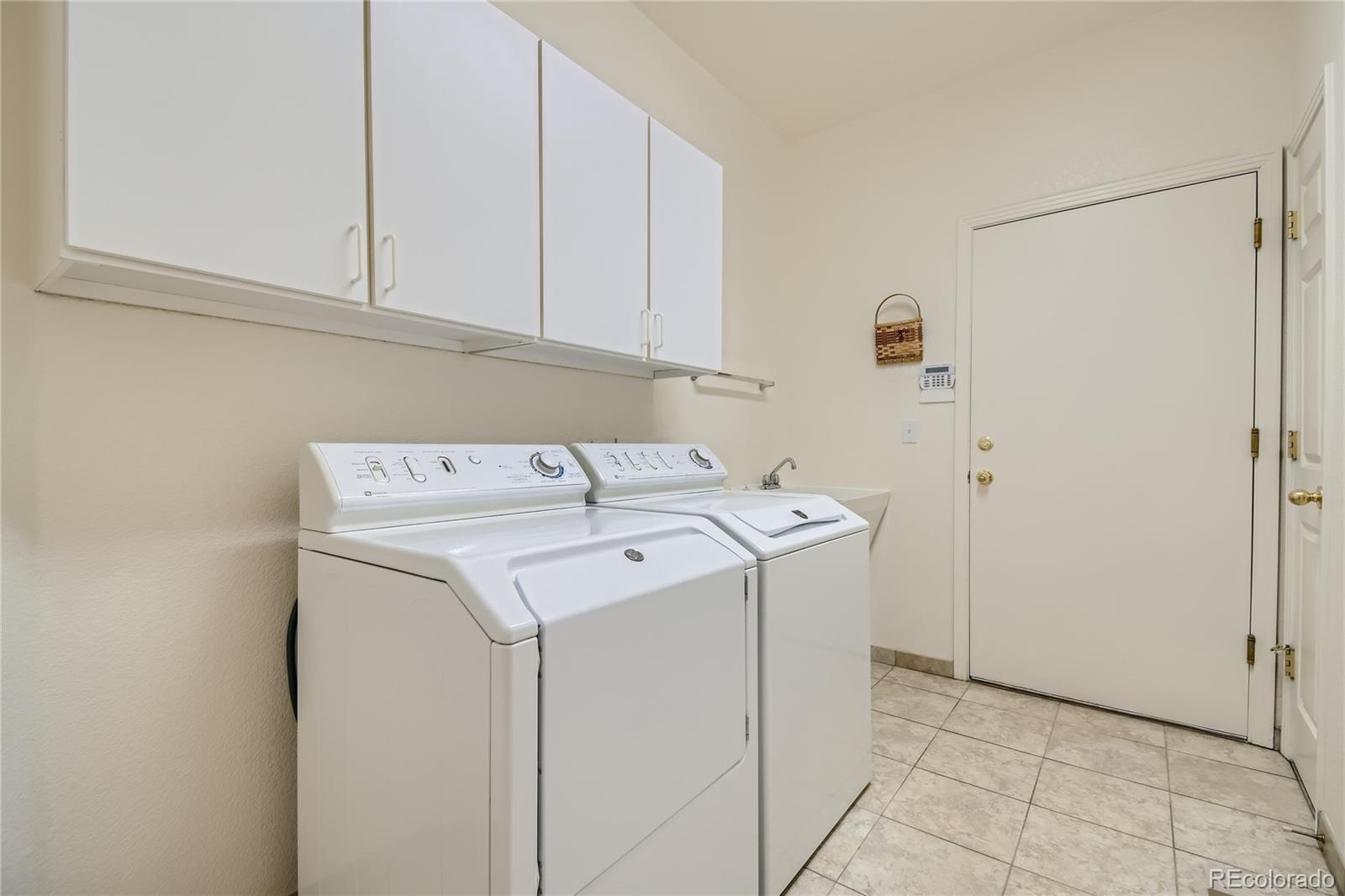 Laundry room has a sink. Washer and dryer stay