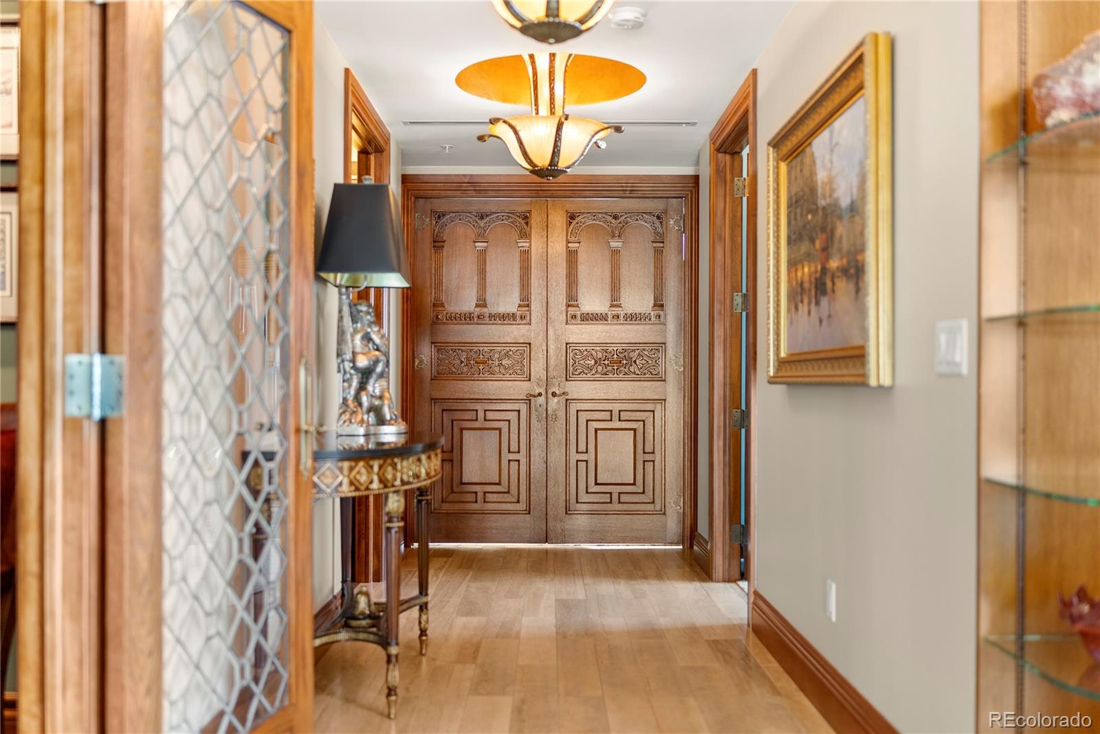 Hallway and custom doors into the primary bedroom