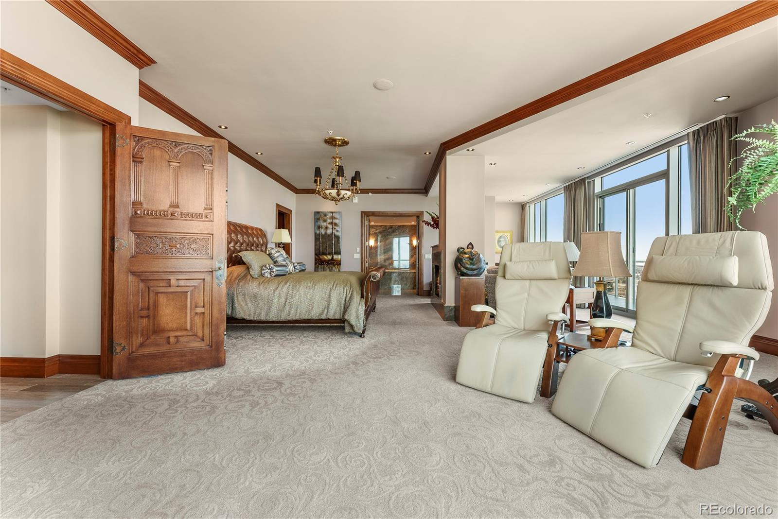 Primary bedroom lounge area with TV