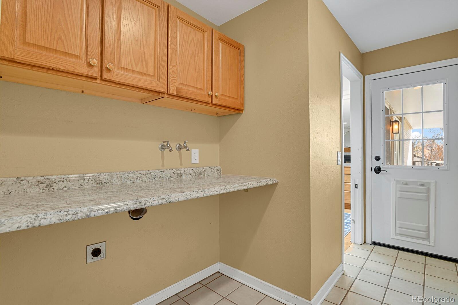 Former laundry area on main level with dog door to backyard