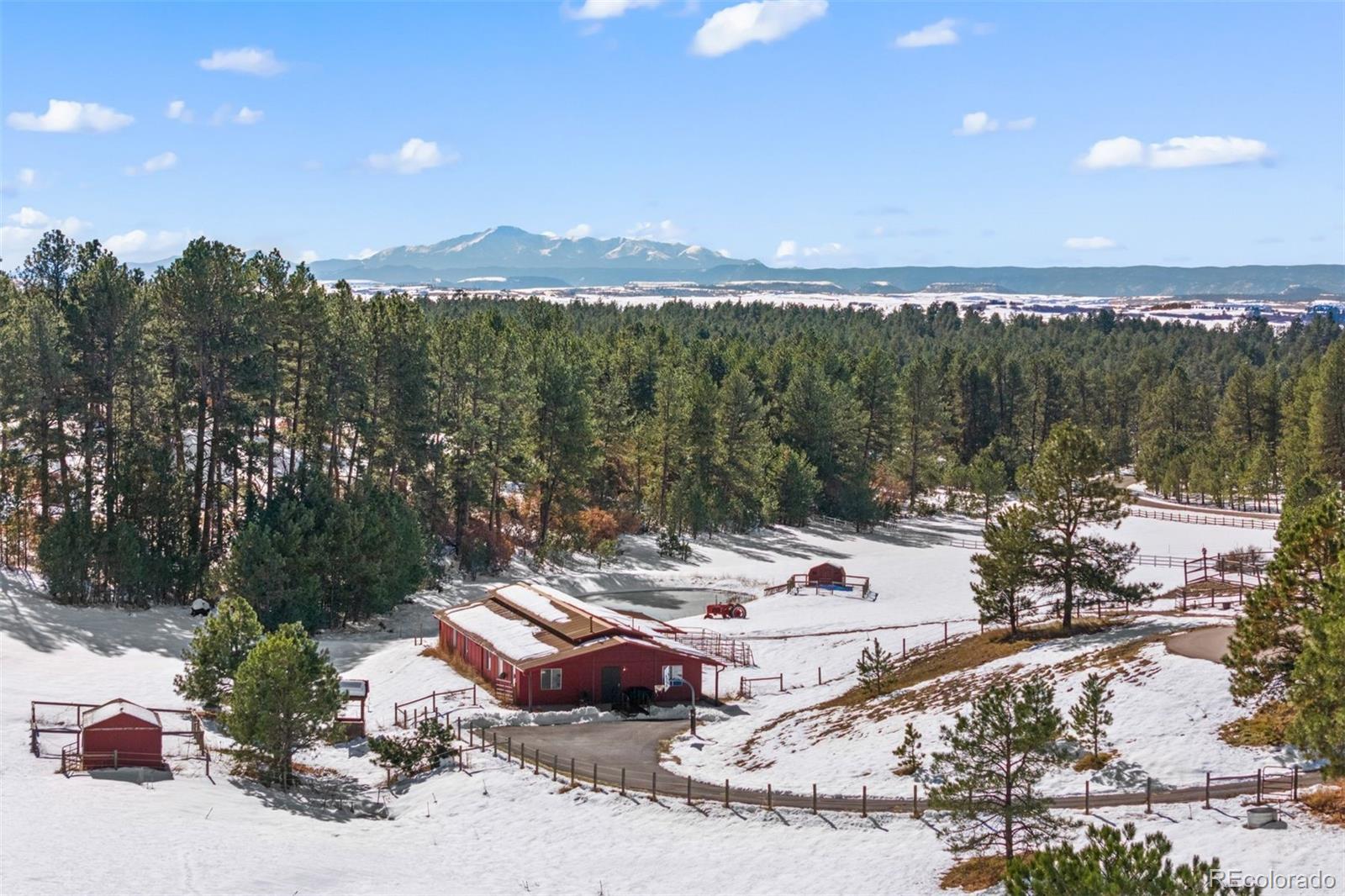 Barn with 4-stalls, tack room, heated storage room, and apartment.