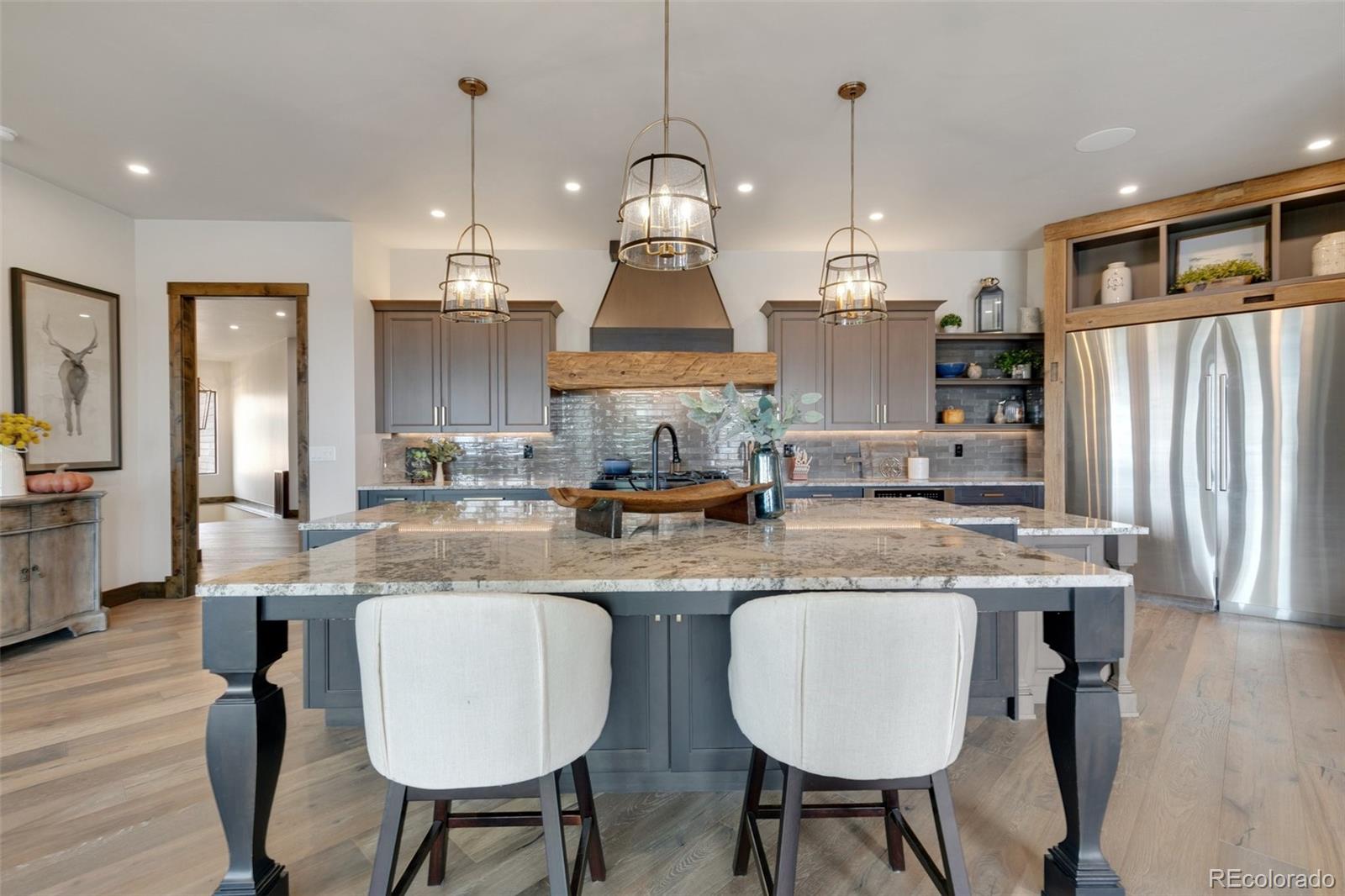 12 x 18 custom granite island with storage; Dacor 2 tower fridge and freezer 6 ft wide with 1820 White Oak barn beam frame.