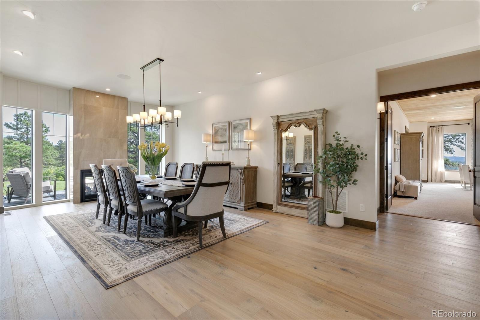 Wall to ceiling windows; shares double sided fireplace with front porch.