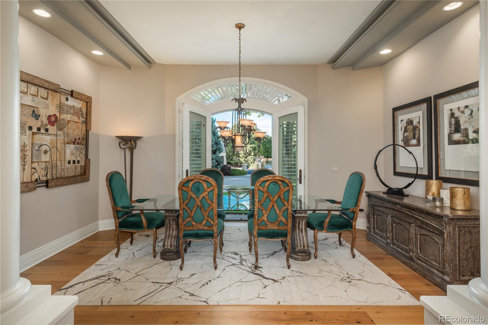 Formal dining area with doors leading to beautiful grounds.