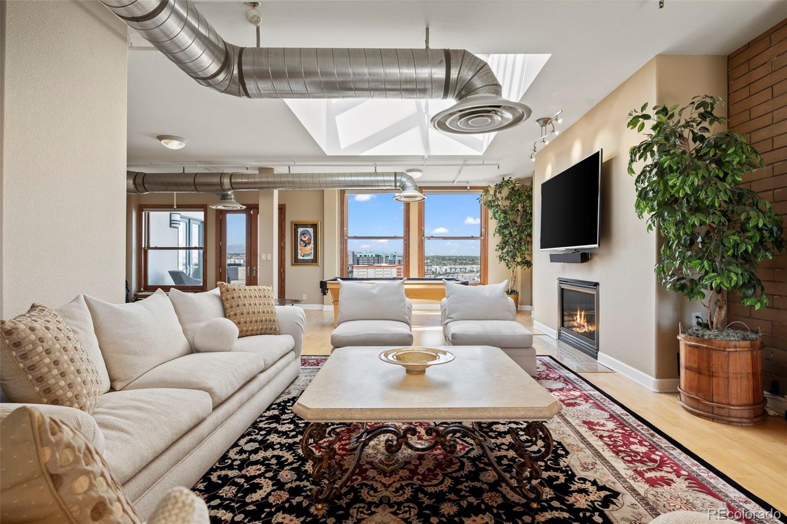 Living Room with gas fireplace and skylights