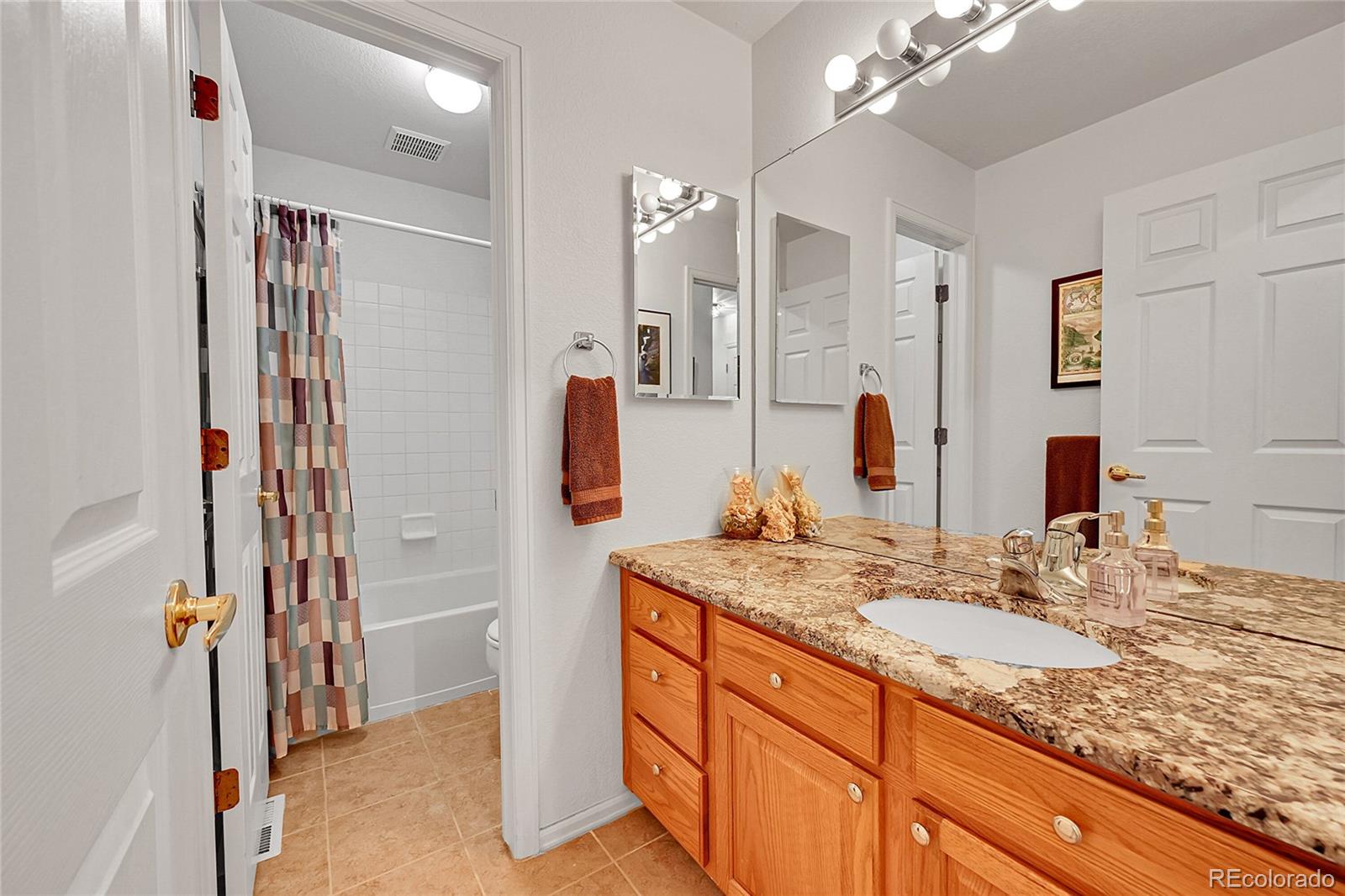 Full hall bathroom with granite counters & separate tub/toilet area