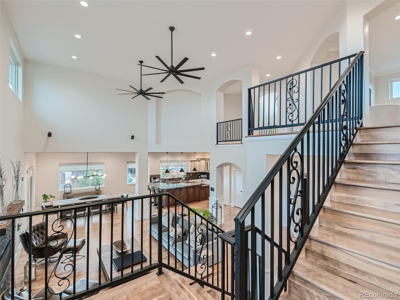 Upper-level primary suite complimented by high tray ceiling, a gas linear fireplace and private deck for morning coffee or evening relaxation.