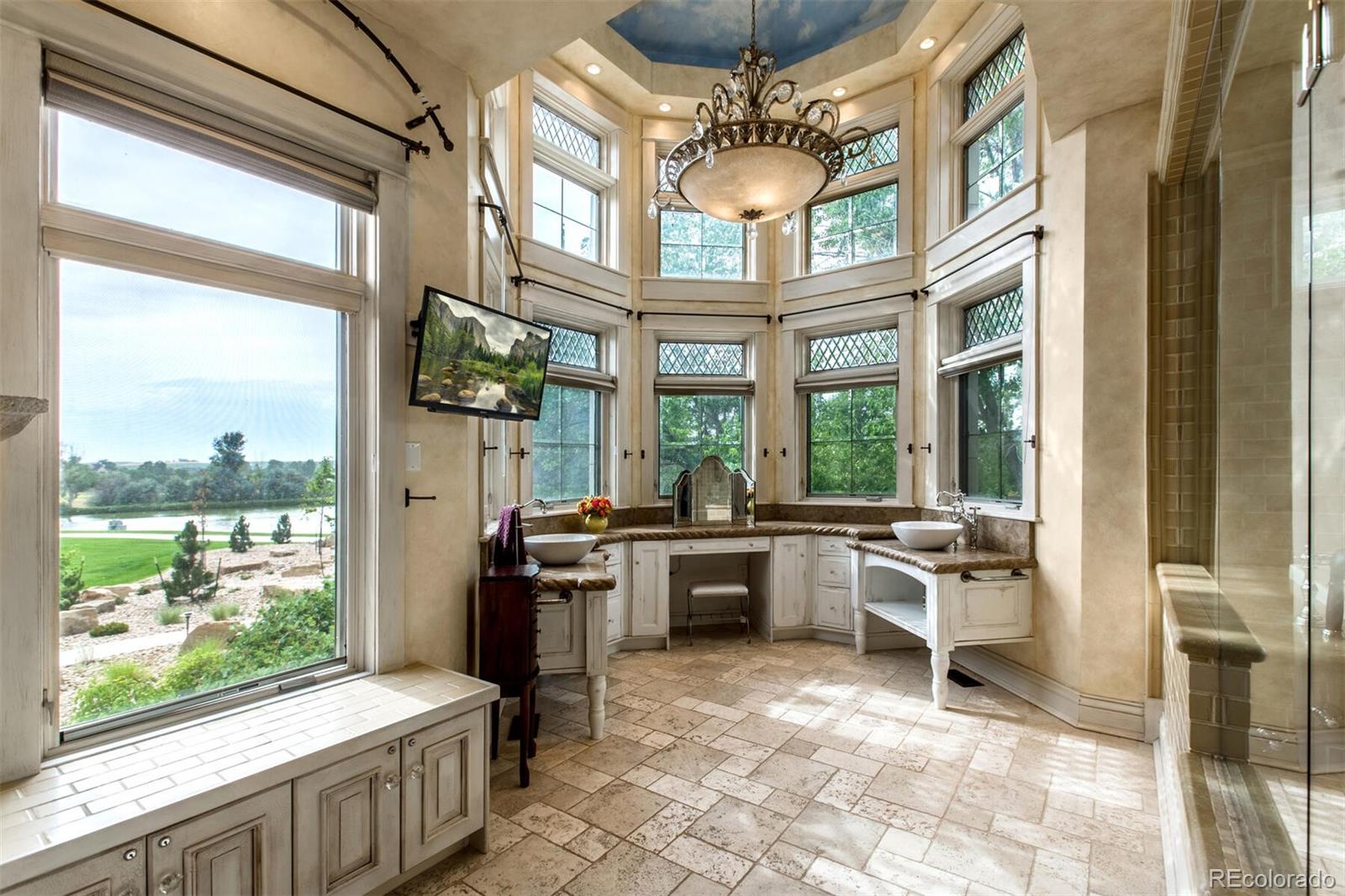 This is the devine ladies' private bathroom, complete with two story beveled glass, crystal chandelier, built in vanity overlooking the lake and a walk-in steam shower/tub to die for. This is luxury and sophistication as it's best.