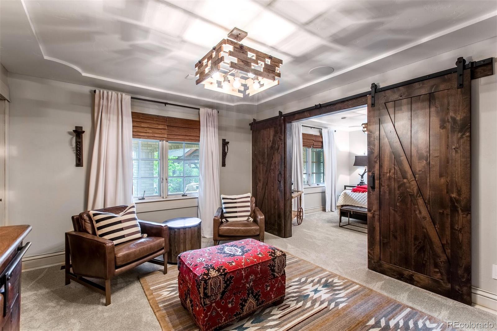 One of the guest suites on the main level, guest wing complete with separate sitting area, coffered ceilings and walk-in closets.