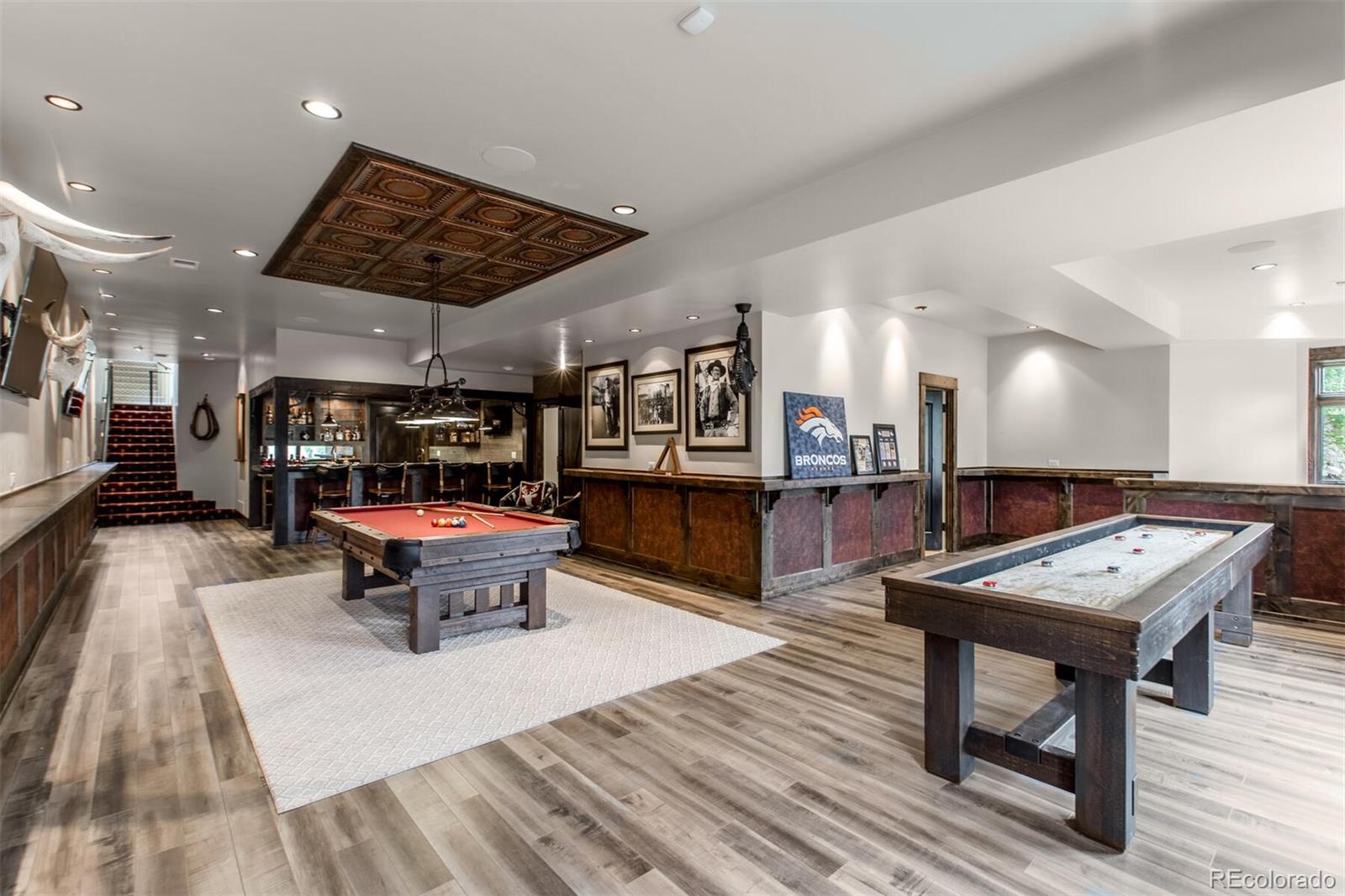 The basement Game Room can only be described as a haven for fun. Whether it's billards or shuffleboard you desire, you'll be entertained with access to a full wet bar with unique styling, beverage fridges and resin coated bar top. Perhaps you would like a