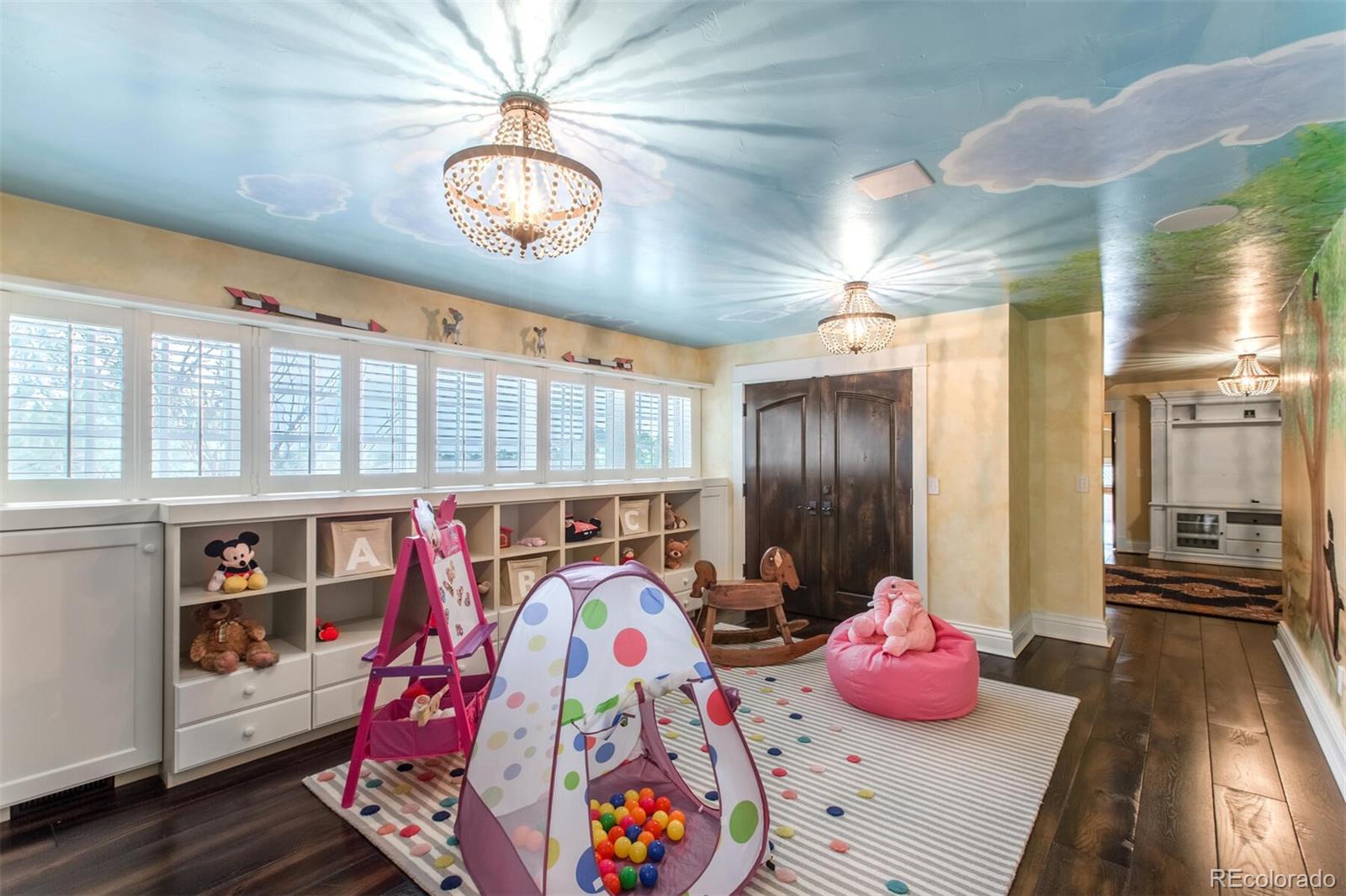 The nursery/kid's suite is located on the upper level, complete with two bedrooms and playroom in the middle (pictured here) with a full bath to share.