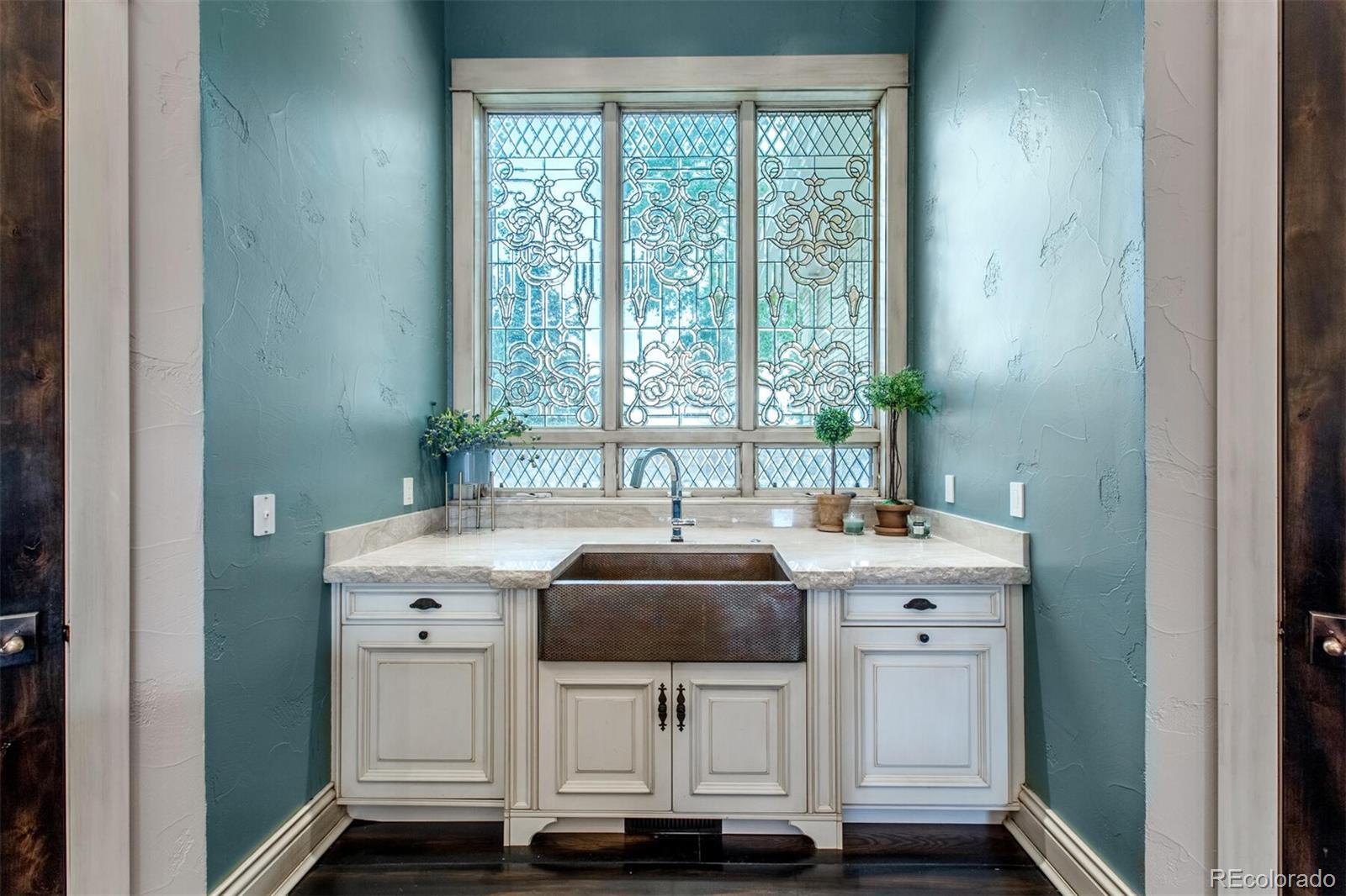 This beveled, leaded glass adorns the copper farm sink and add light and texture to this perfect space.