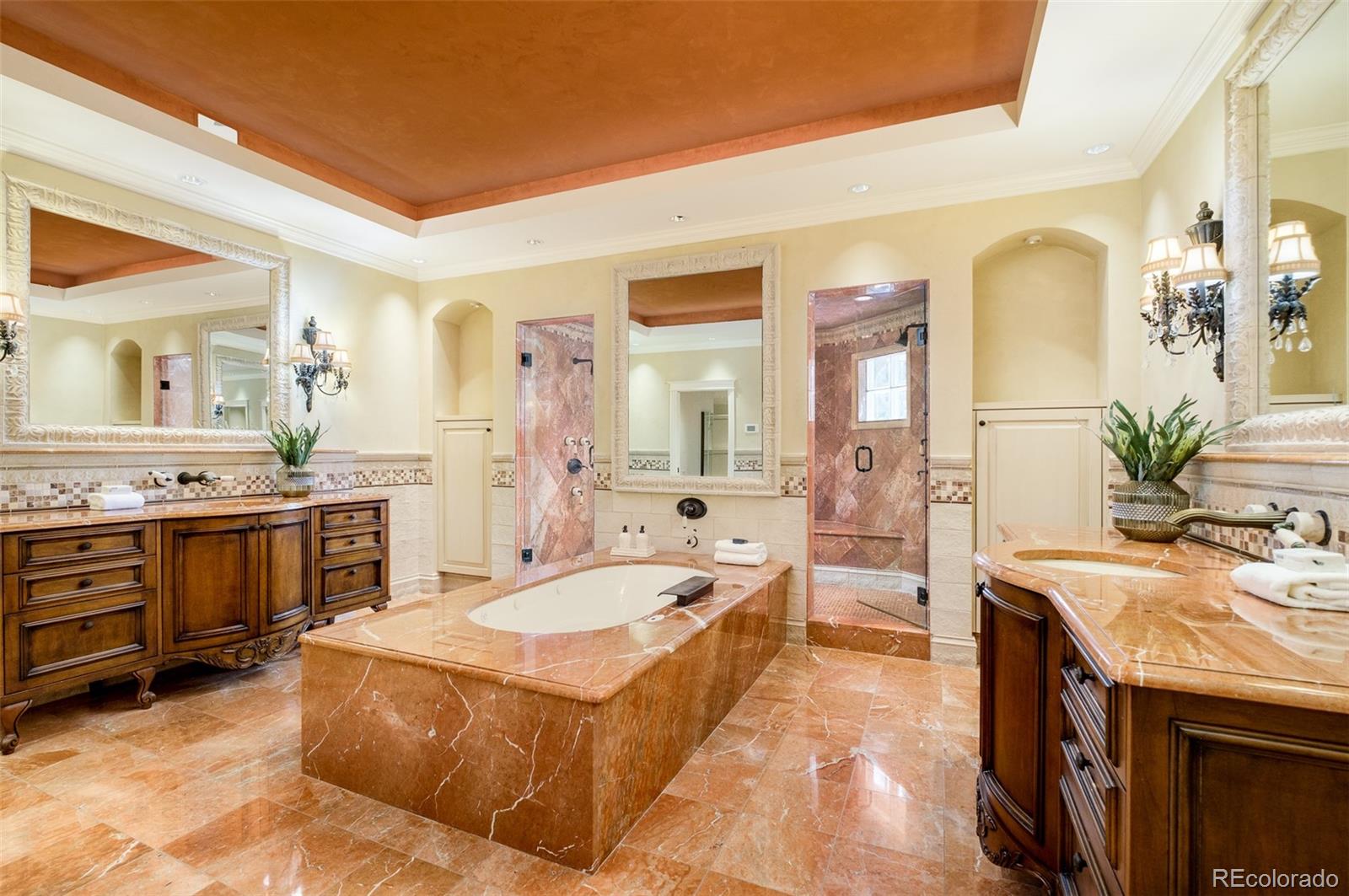 Primary bathroom features tile from the Belagio, heated floors, a hidden television above the bathtub and more.