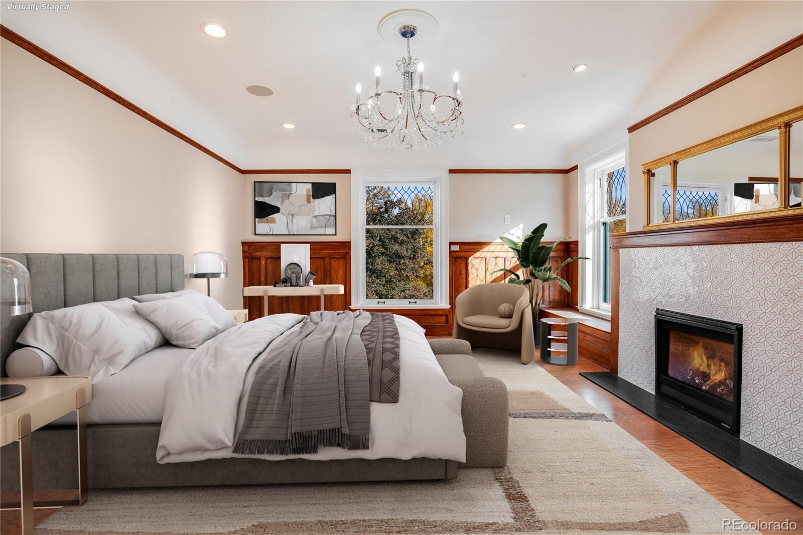 staged primary bedroom with fireplace