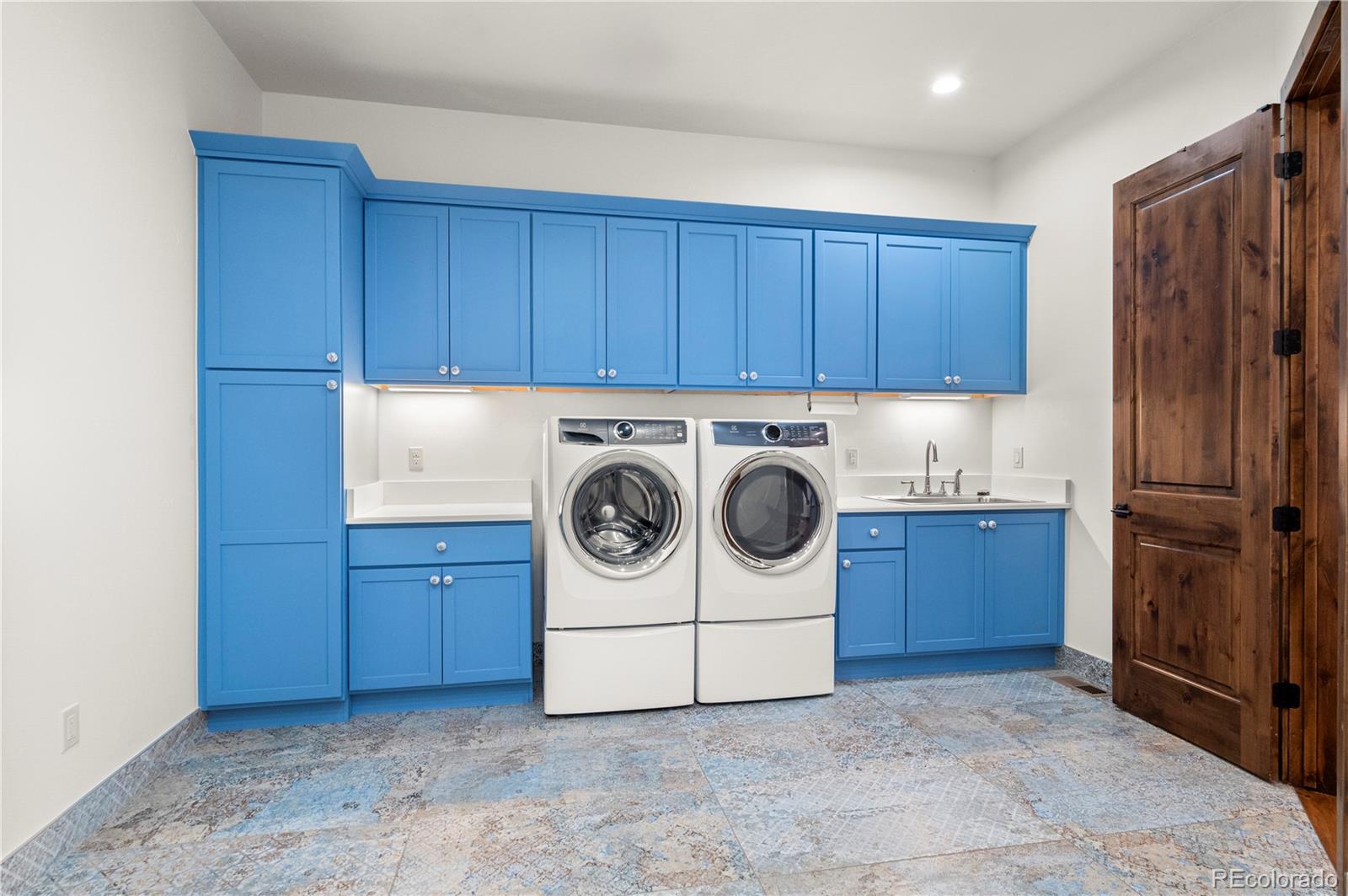 Main Level Laundry/Mud Room off garage with space for multiple lockers.