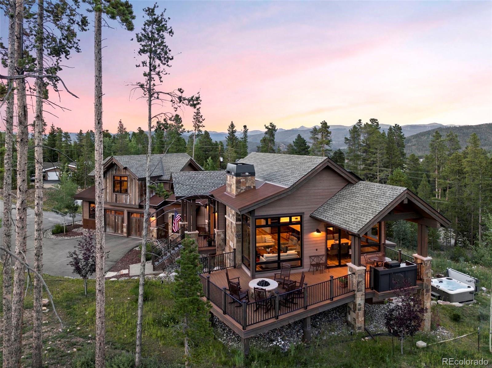 Beautiful home with custom stonework, oversized deck and ironworks log firepit.