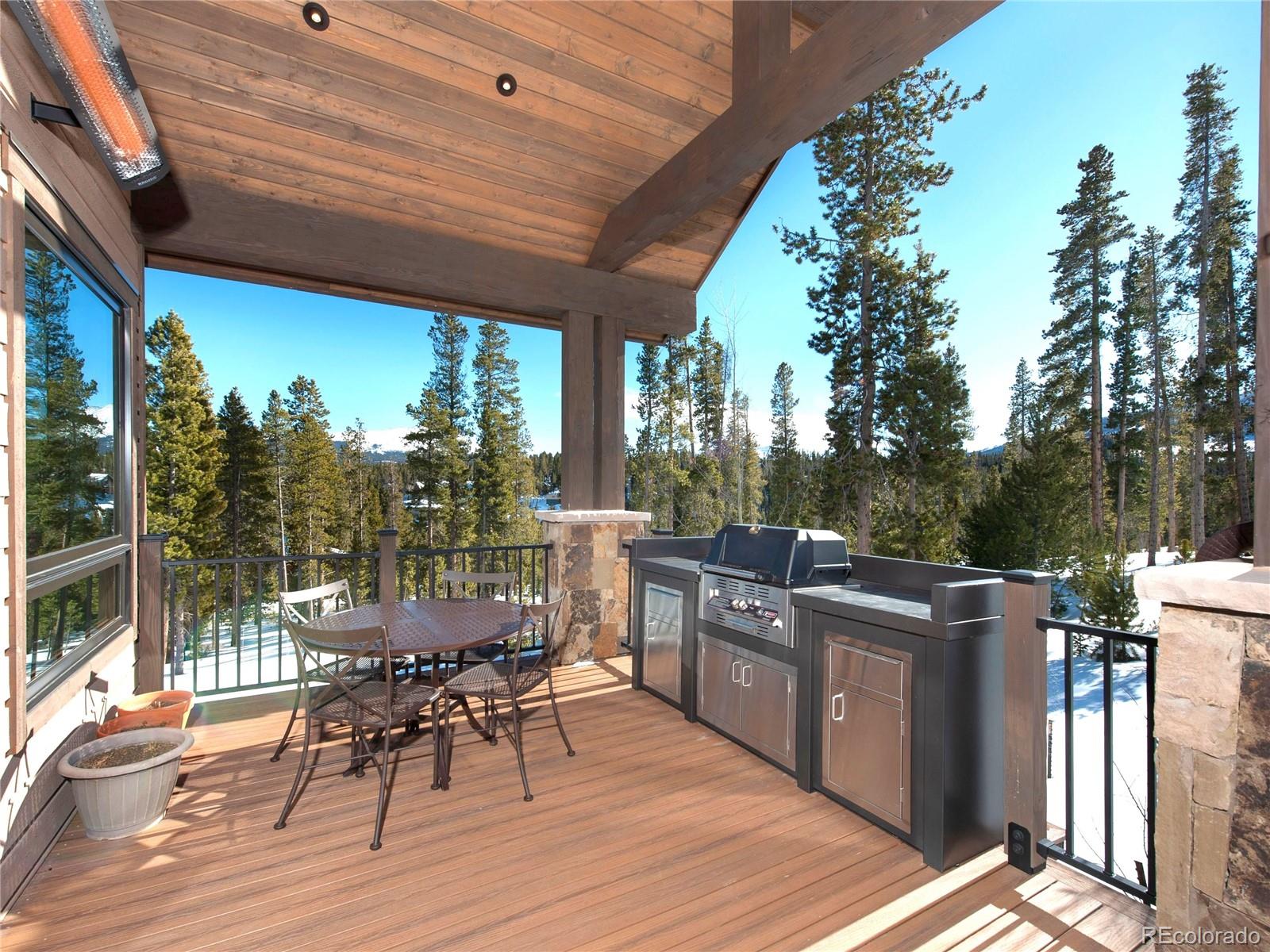 Outdoor kitchen with a heater up above to keep you warm after a day of skiing