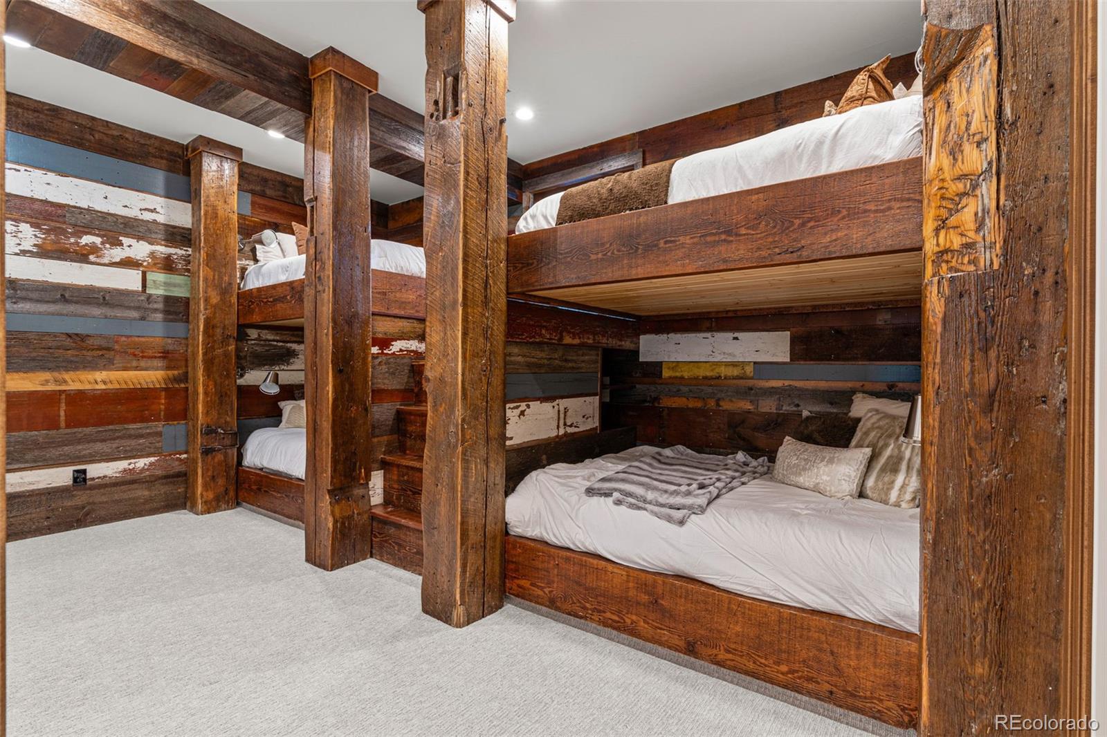 bunkroom with 125-year-old reclaimed barn wood featuring 4 queen bunks