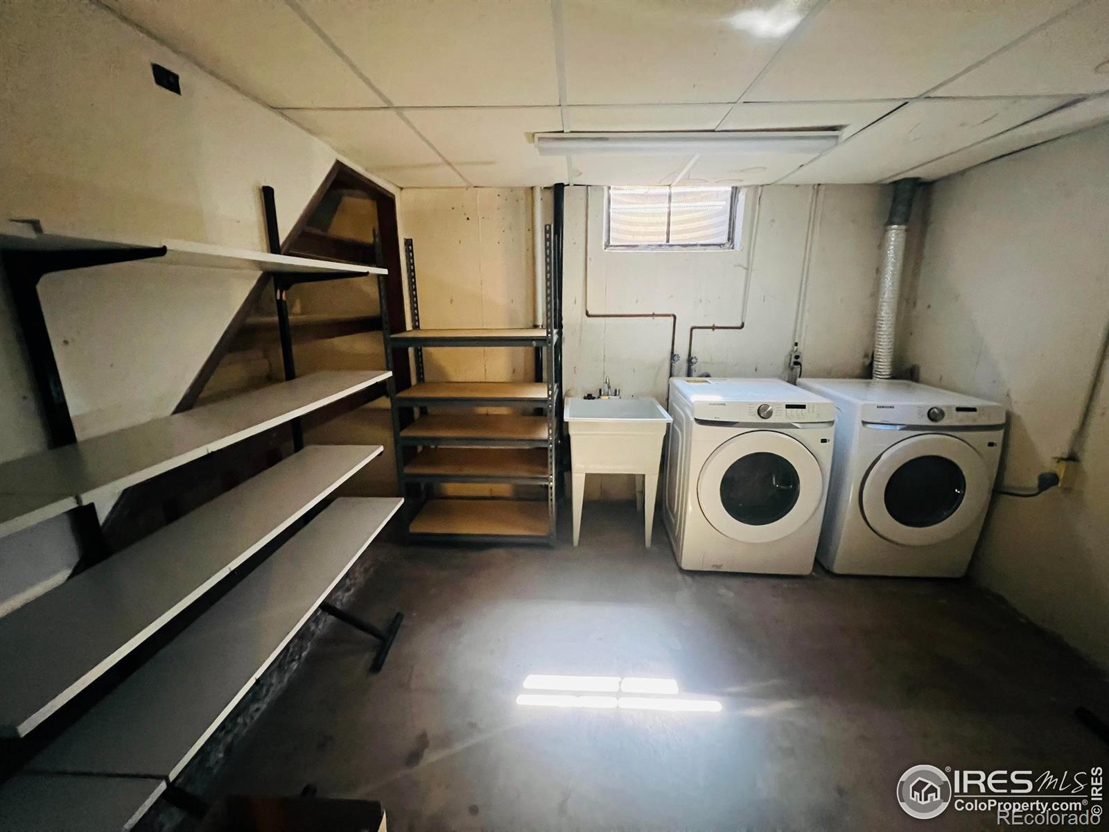 Laundry room with shelving and storage