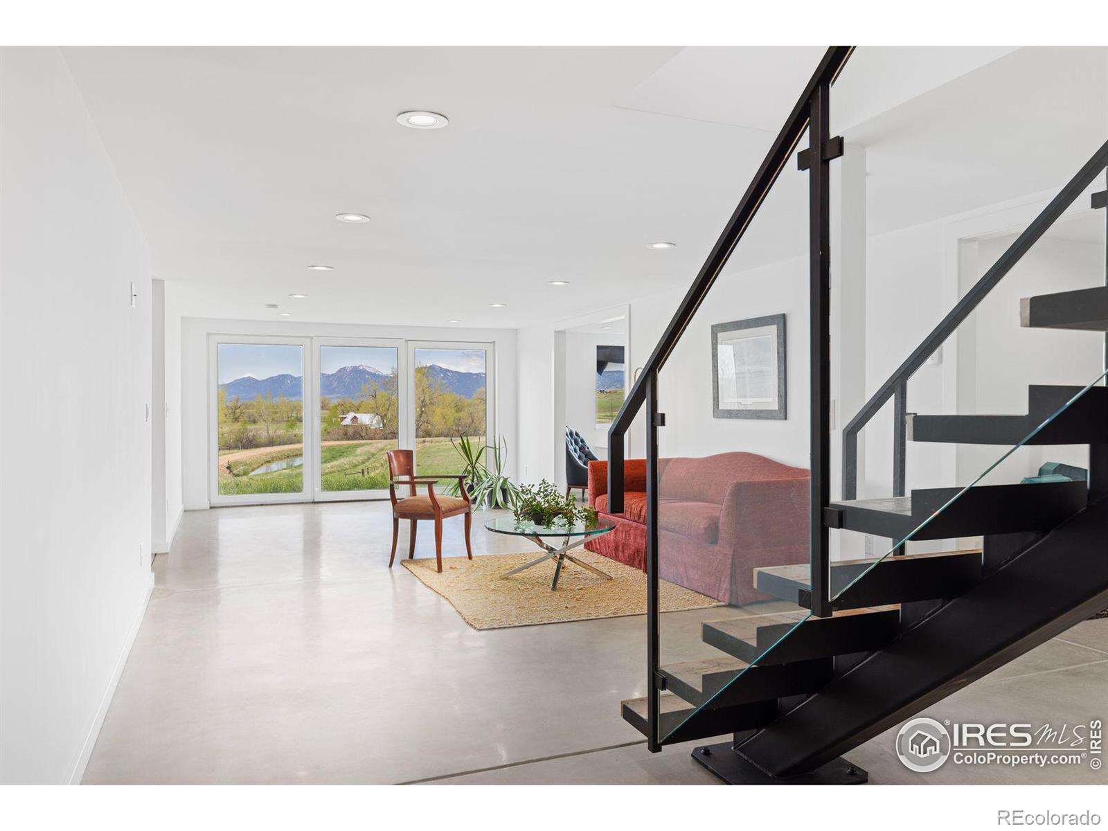 Lower Level Living Area with Oversized Window Doors Looking South Across the Property