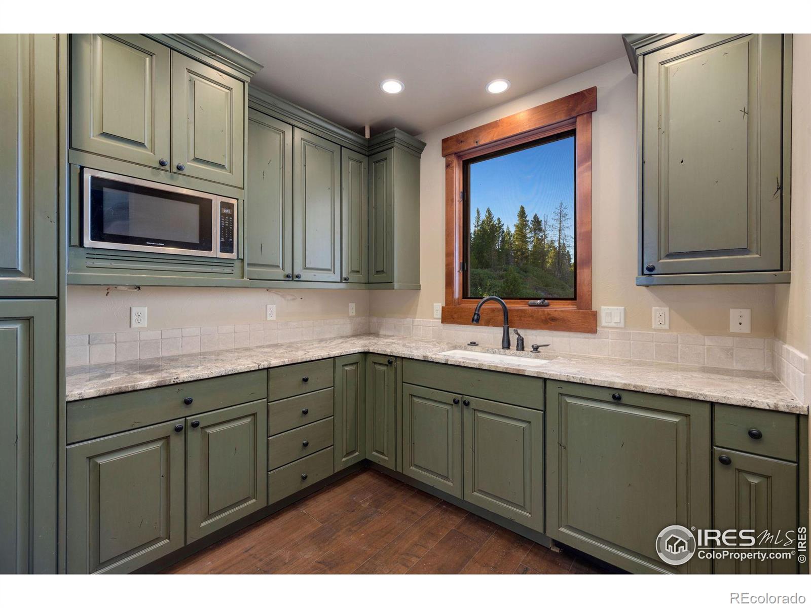 Second prep kitchen with additional custom cabinetry, dishwasher, sink and microwave